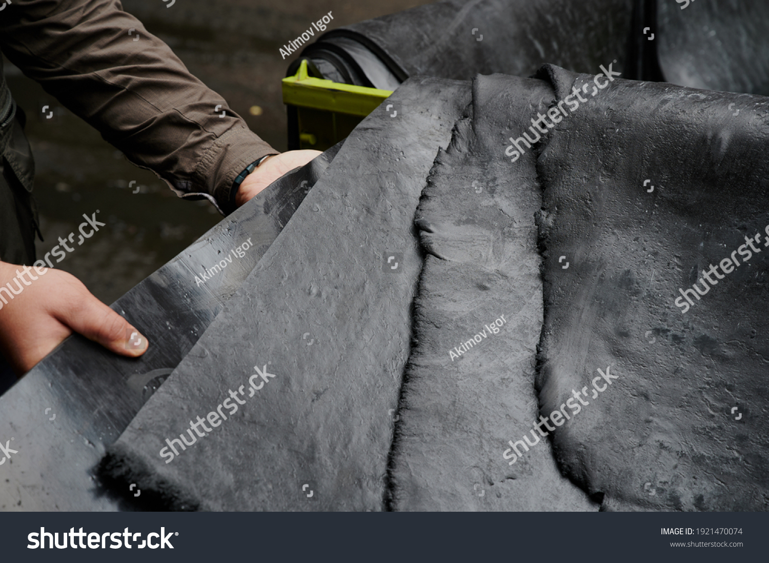 One of the first stages of production of rubber products at the plant. Close-up of raw material seam texture. Medium wholesale manufacturing technology, #1921470074