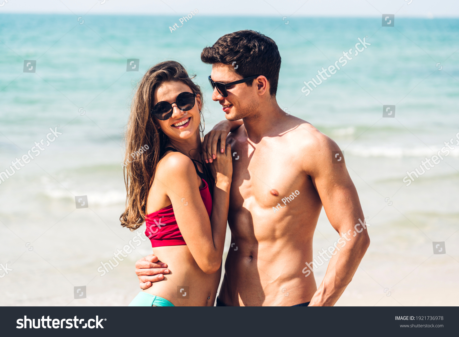 Vacation romantic lovers young happy couple hug and standing on sand at sea having fun and relaxing together on tropical beach.Summer vacations #1921736978