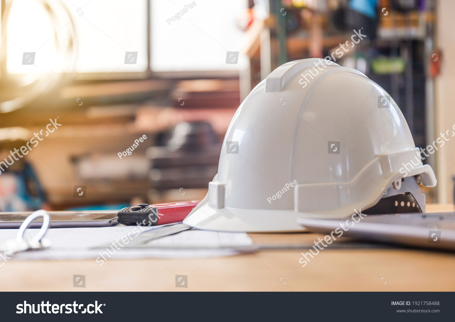 Construction concepts. White safety helmets blueprints on the engineering desks. Hard safety wear helmet hat on desks at construction site #1921758488