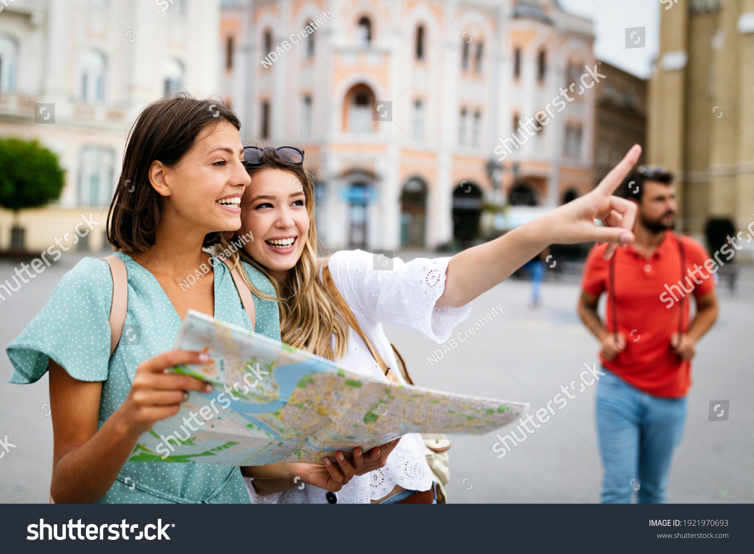 Happy friends enjoying sightseeing tour in the city. #1921970693