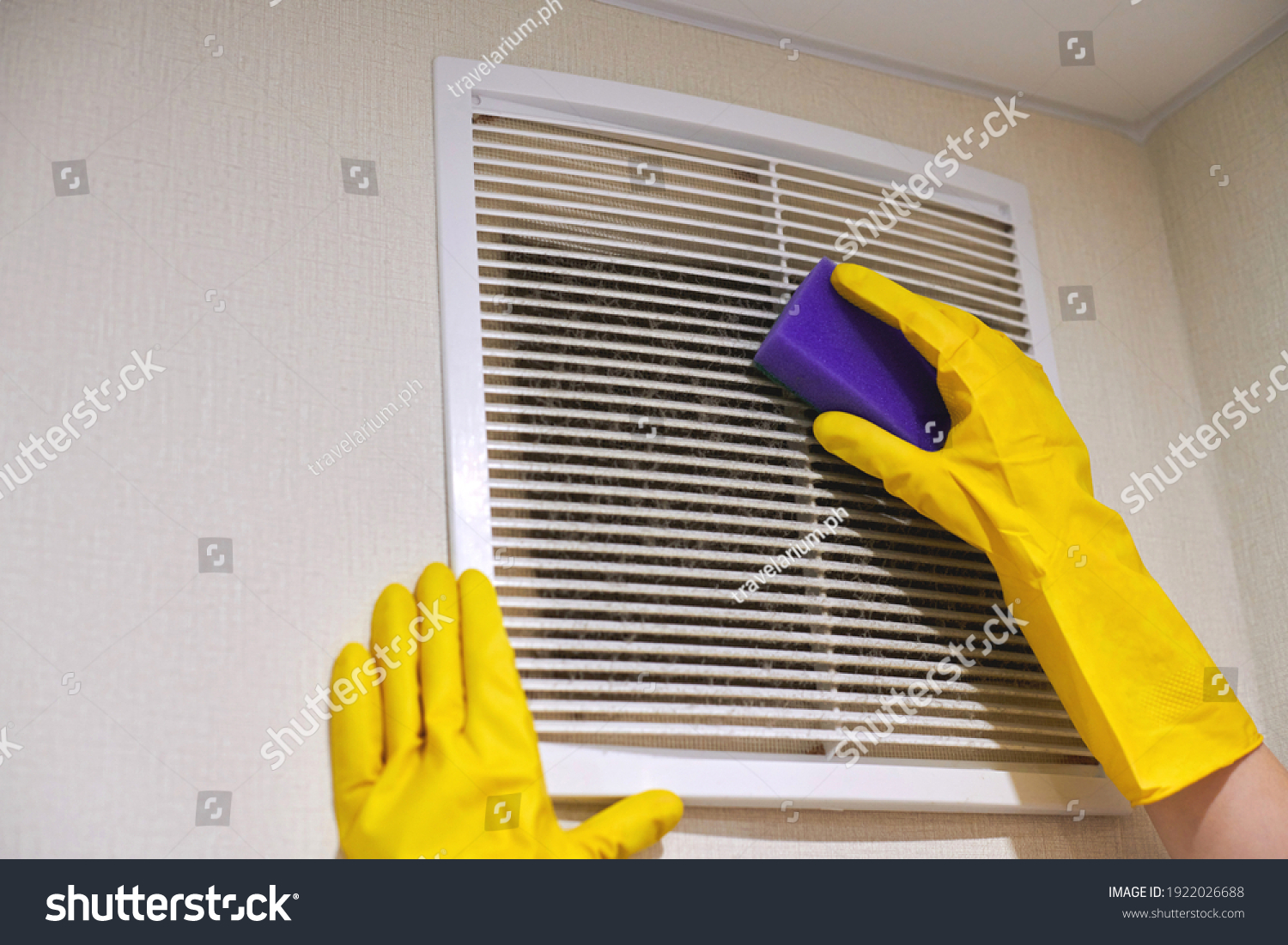 Hands in protective rubber gloves cleaning dusty air ventilation grill of HVAC. Cleaning service concept. #1922026688
