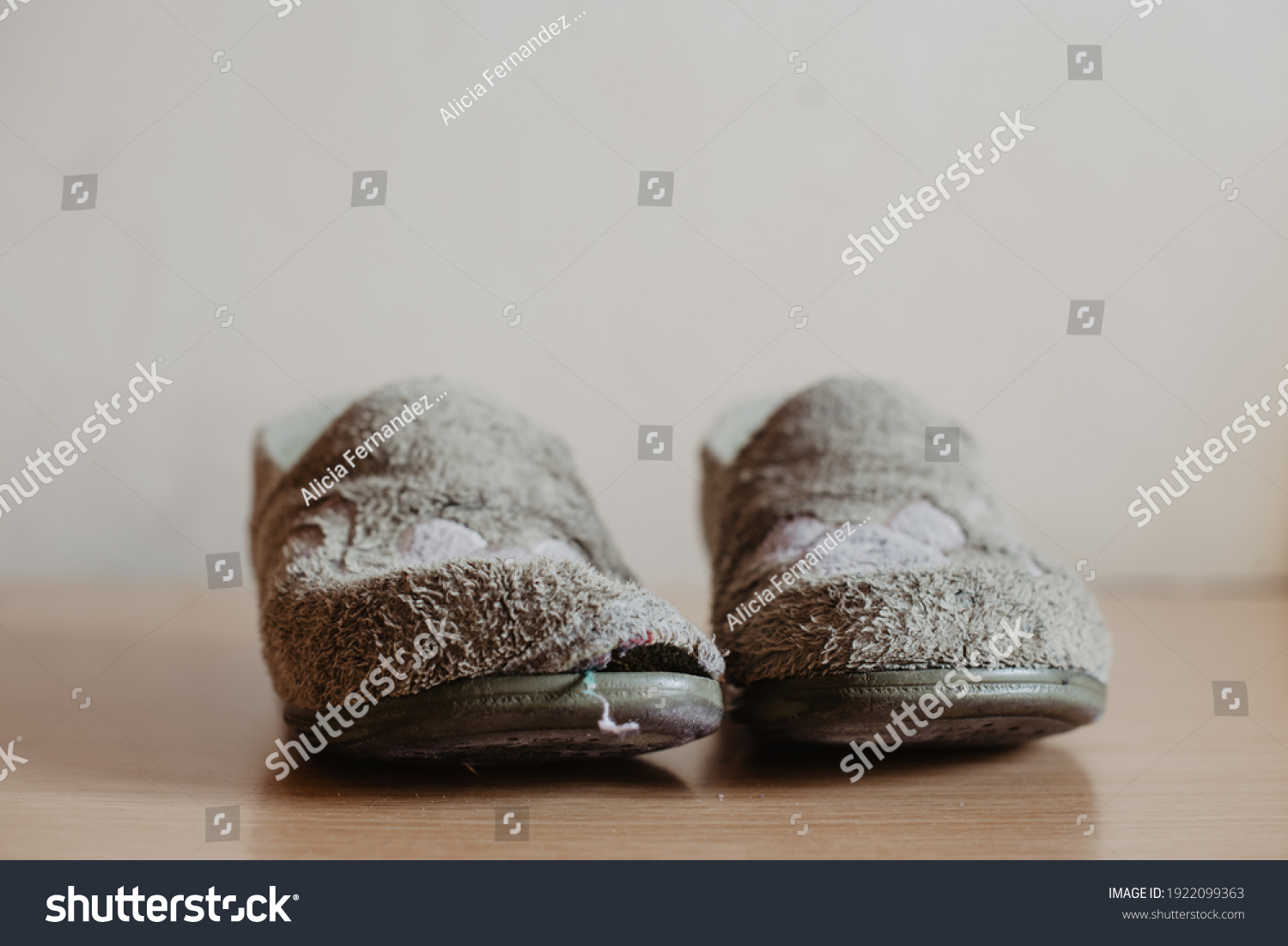 Two very worn, torn and widely used house slippers with a hole. Women's or girl's house slippers #1922099363