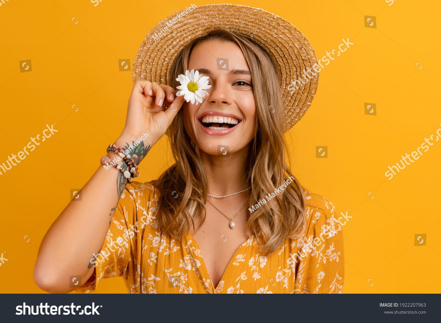beautiful attractive stylish woman in yellow dress and straw hat holding daisy flower romantic mood posing on yellow background isolated in love summer fashion trend style, natural look #1922207963
