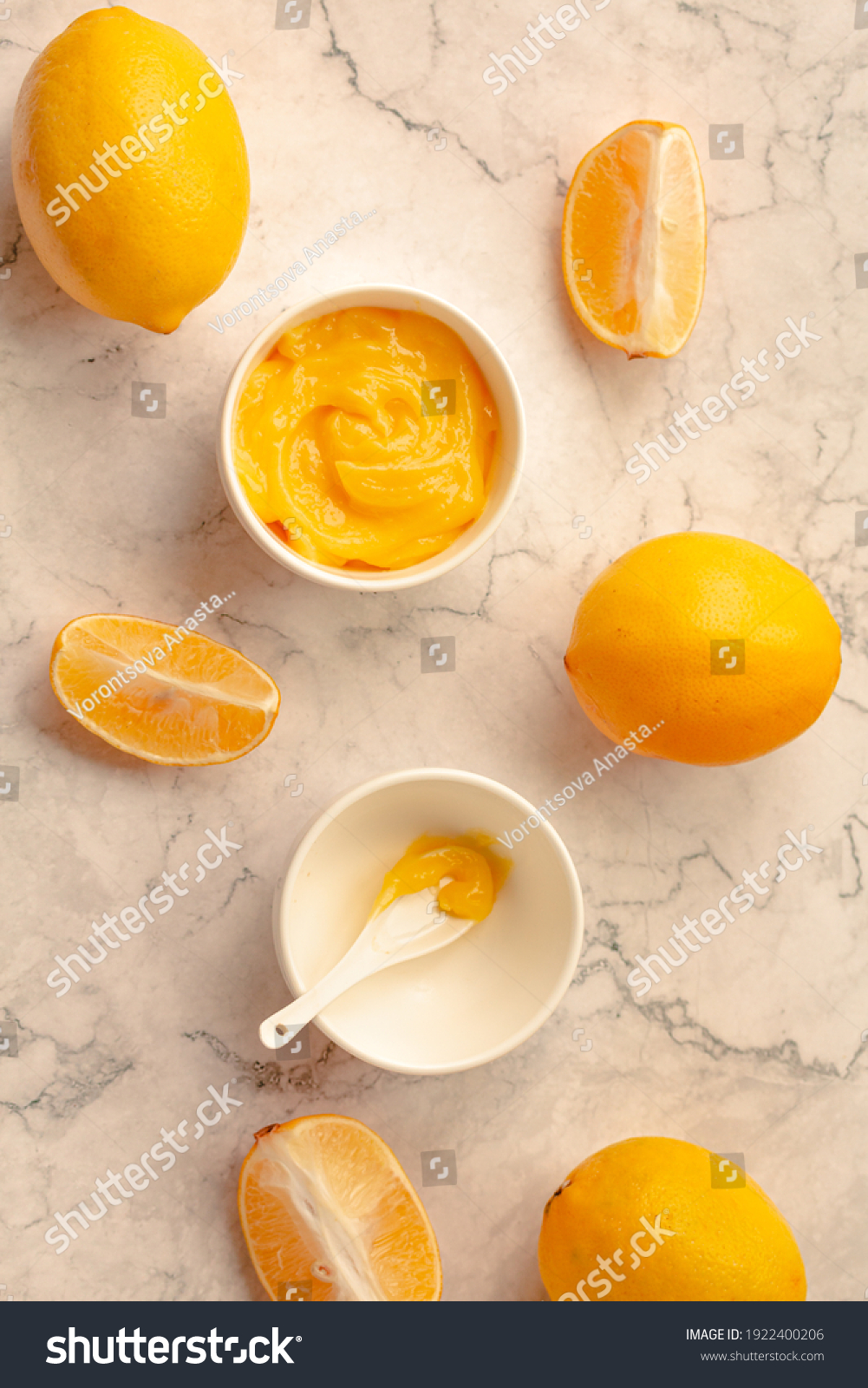 Delicious homemade tangy lemon curd decorated with fresh fruit on marble background.Top view. #1922400206