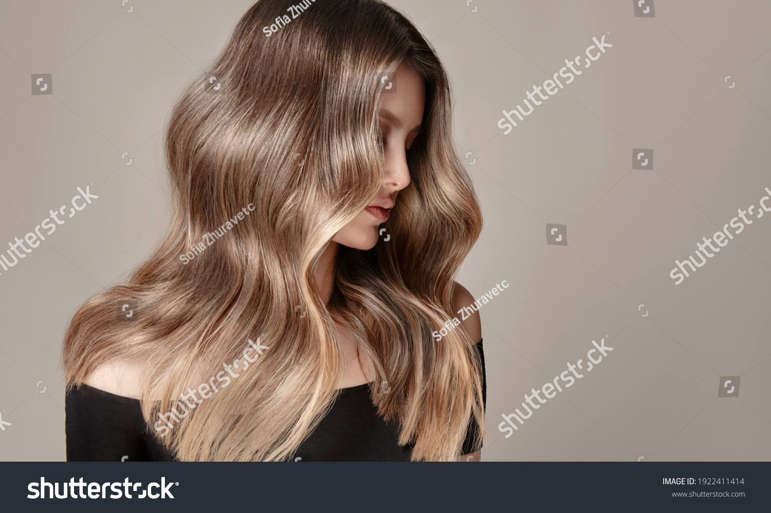 Beauty  girl with long  and   shiny wavy  Hair ,coloring and toning, shatush and balayash .  Beautiful   woman model with curly hairstyle . #1922411414