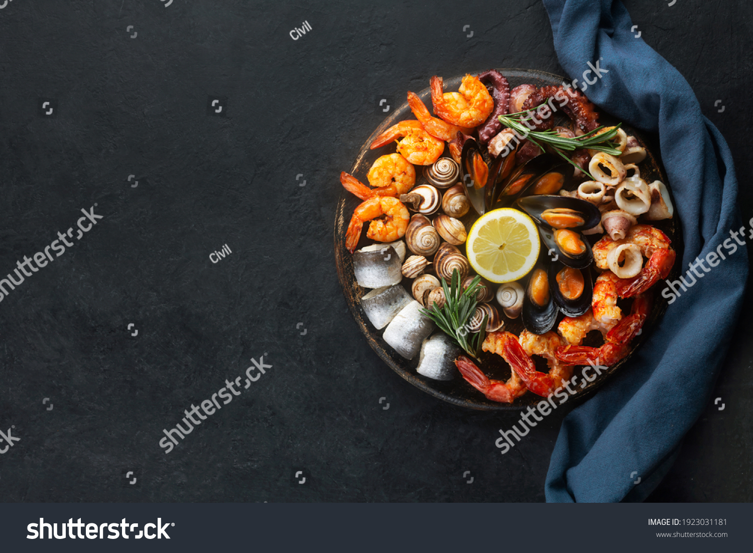 Seafood charcuterie platter board with shrimp, oysters, fish and octopus on black background and free space #1923031181