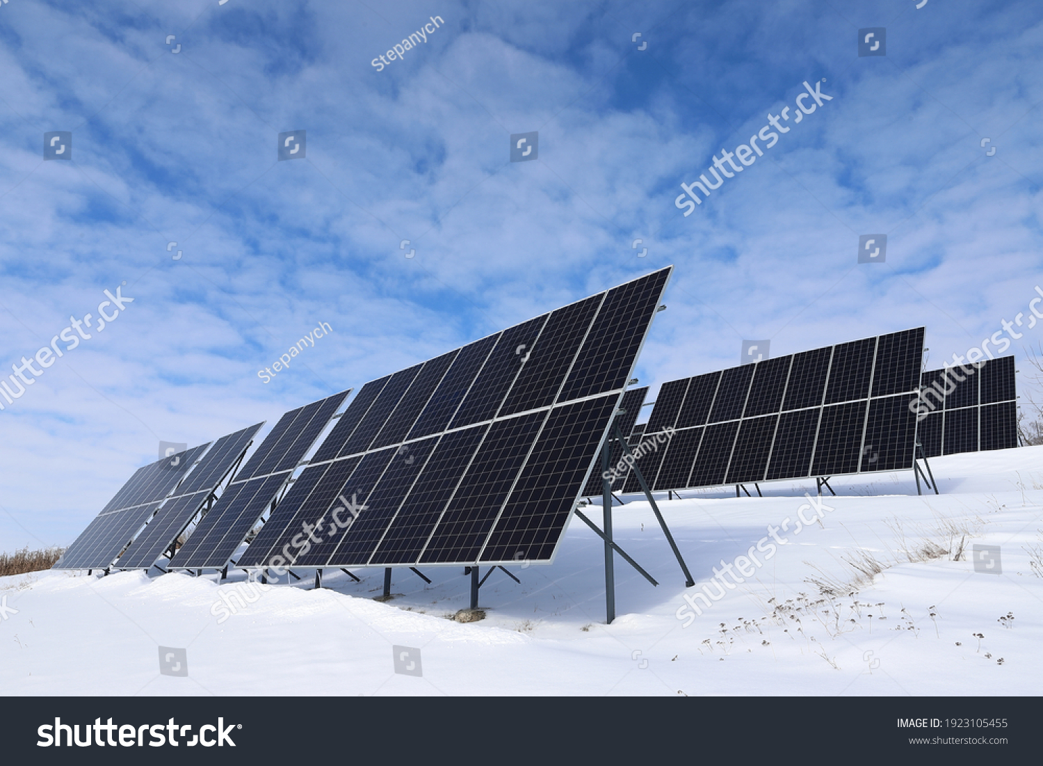 Solar panels Photovoltaic cells on a background of white and blue sky and snow. Alternative ecological solar energy. #1923105455