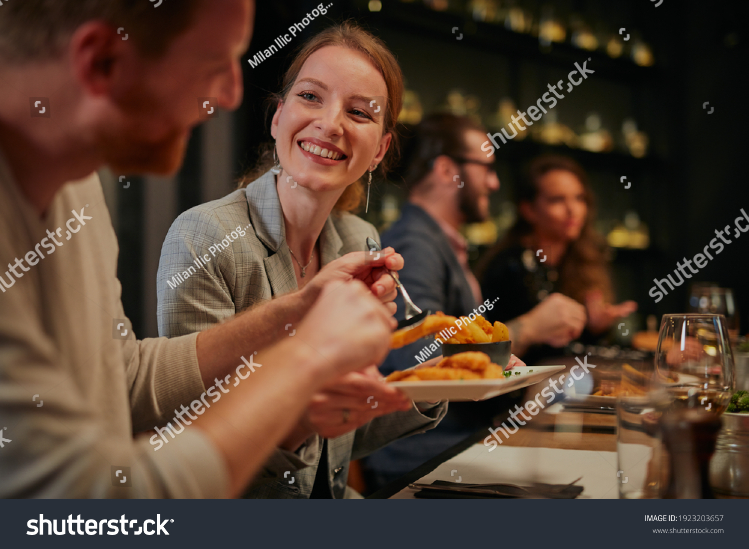 Attractive friends sitting in restaurant and having a good time. #1923203657