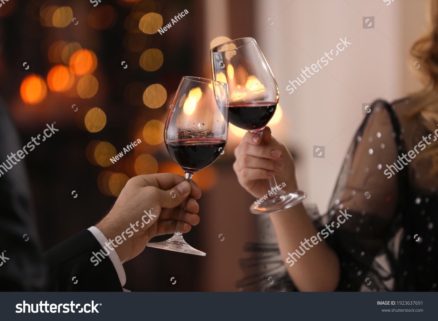Couple clinking glasses at Valentine's day dinner in restaurant, closeup #1923637691