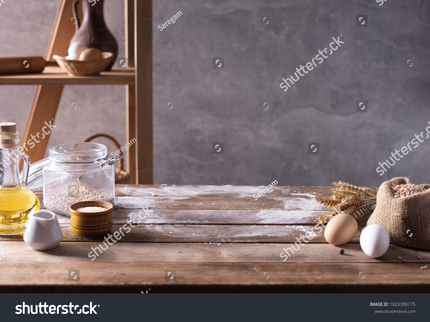 Bakery ingredients for homemade bread cooking or baking on table. Food set at wooden tabletop near wall background texture with copy space. Front view of bakery concept #1923709775