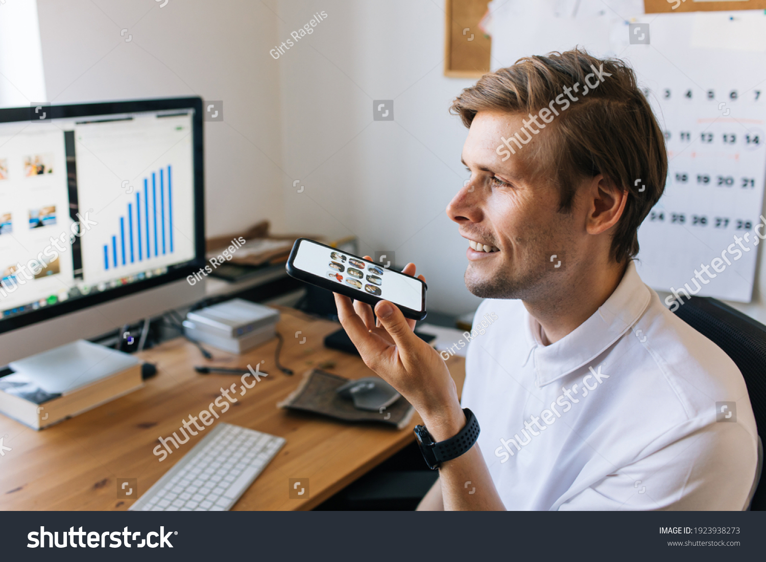 Man using mobile phone. Social media use at work. Work from home Clubhouse the voice-only social media app. Smiling male talking on the phone social platform built around drop-in audio chat #1923938273