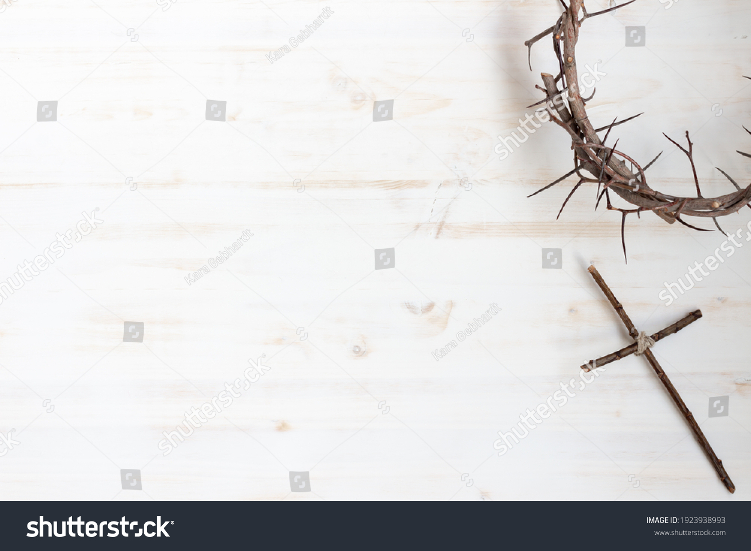 Crown of thorns with wood cross on white background with copy space #1923938993