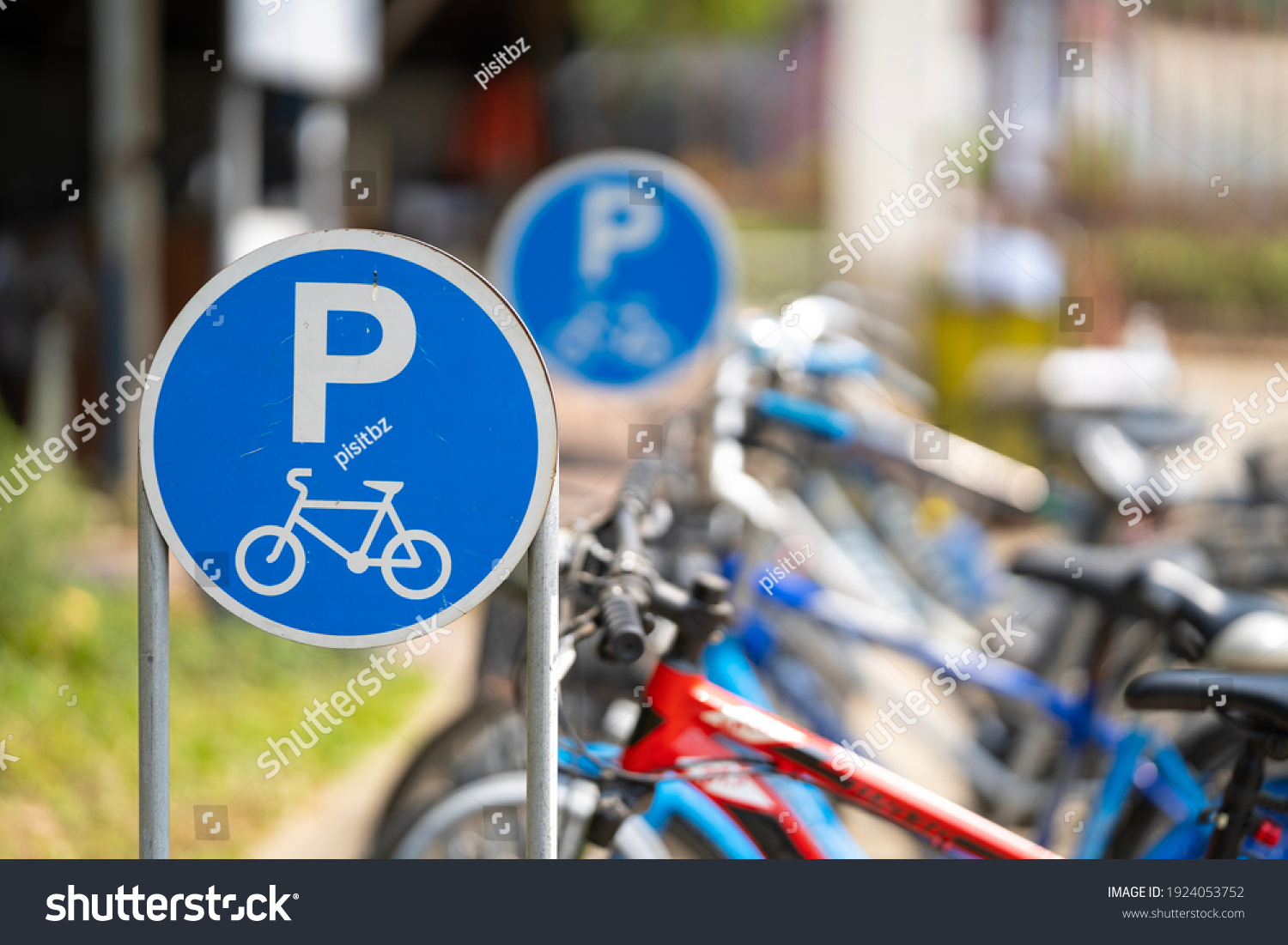 Bike parking sign with a blurred bicycle background. #1924053752
