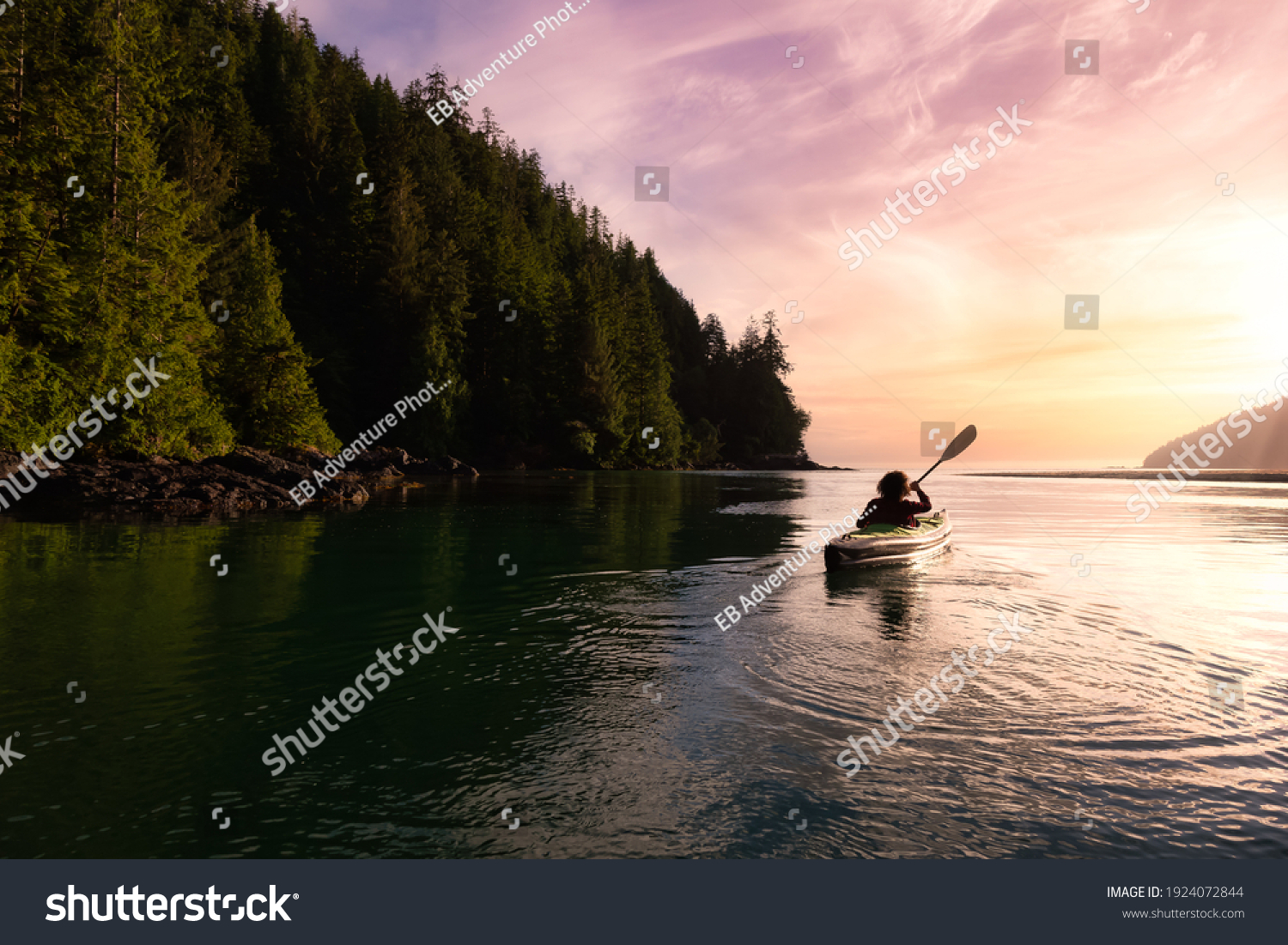 Adventurous Girl kayaking in the Pacific Ocean. Sunset Sky Art Render. Taken in San Josef Bay, Cape Scott, Northern Vancouver Island, British Columbia, Canada. Adventure Travel Concept #1924072844