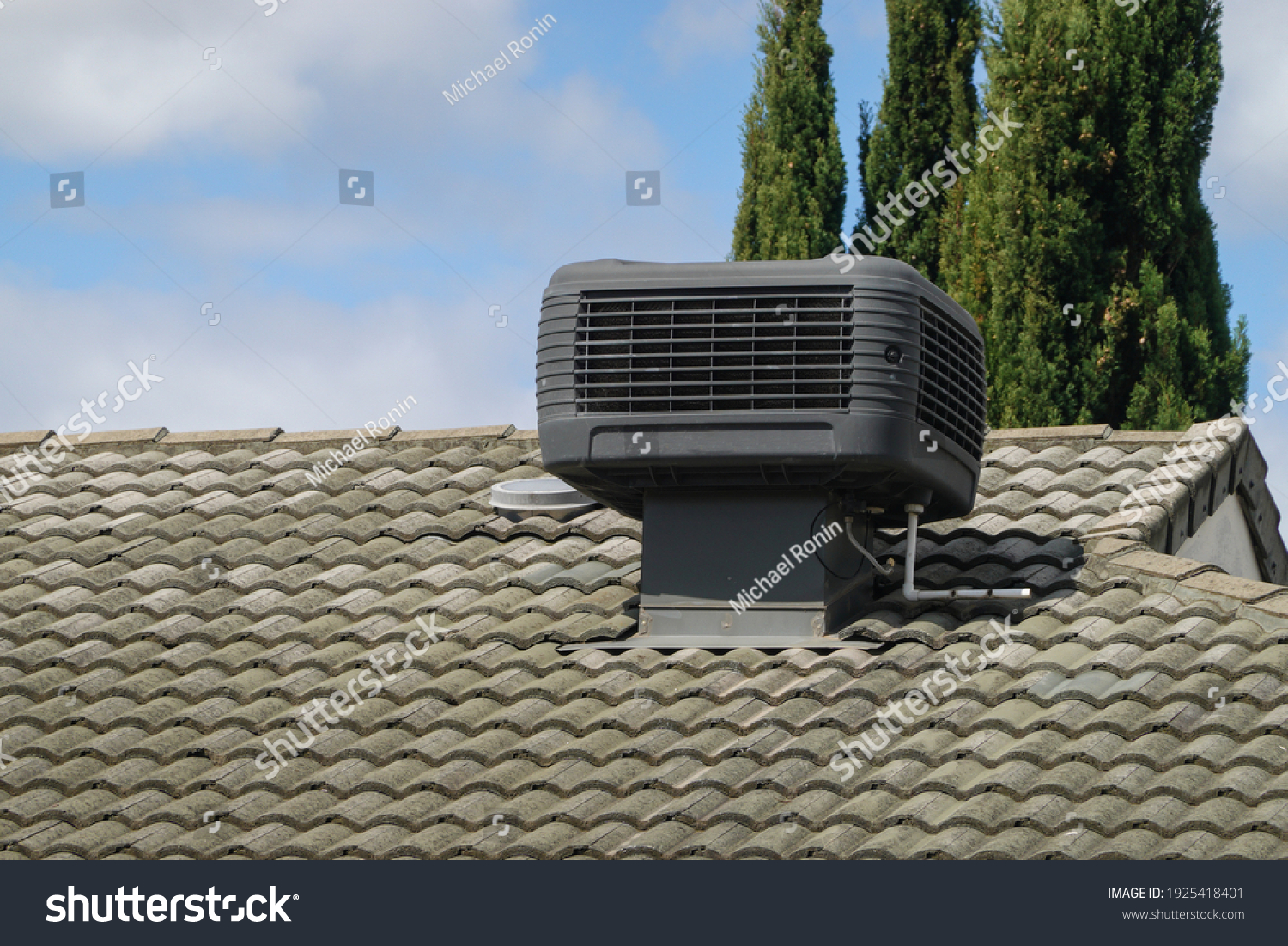 Older Style Evaporative Cooler on Roof of House #1925418401