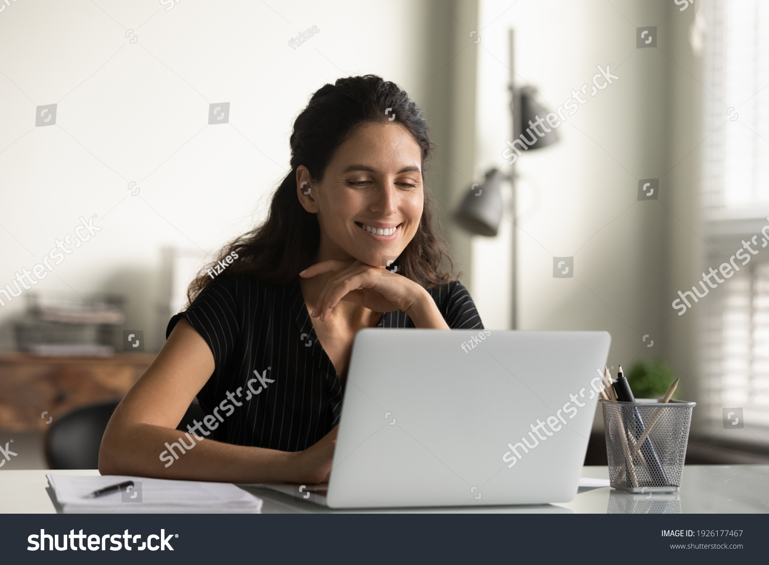 Close up smiling young woman looking at laptop screen, reading good news in message, watching video, chatting in social network or shopping online at home, enjoying leisure time with computer #1926177467