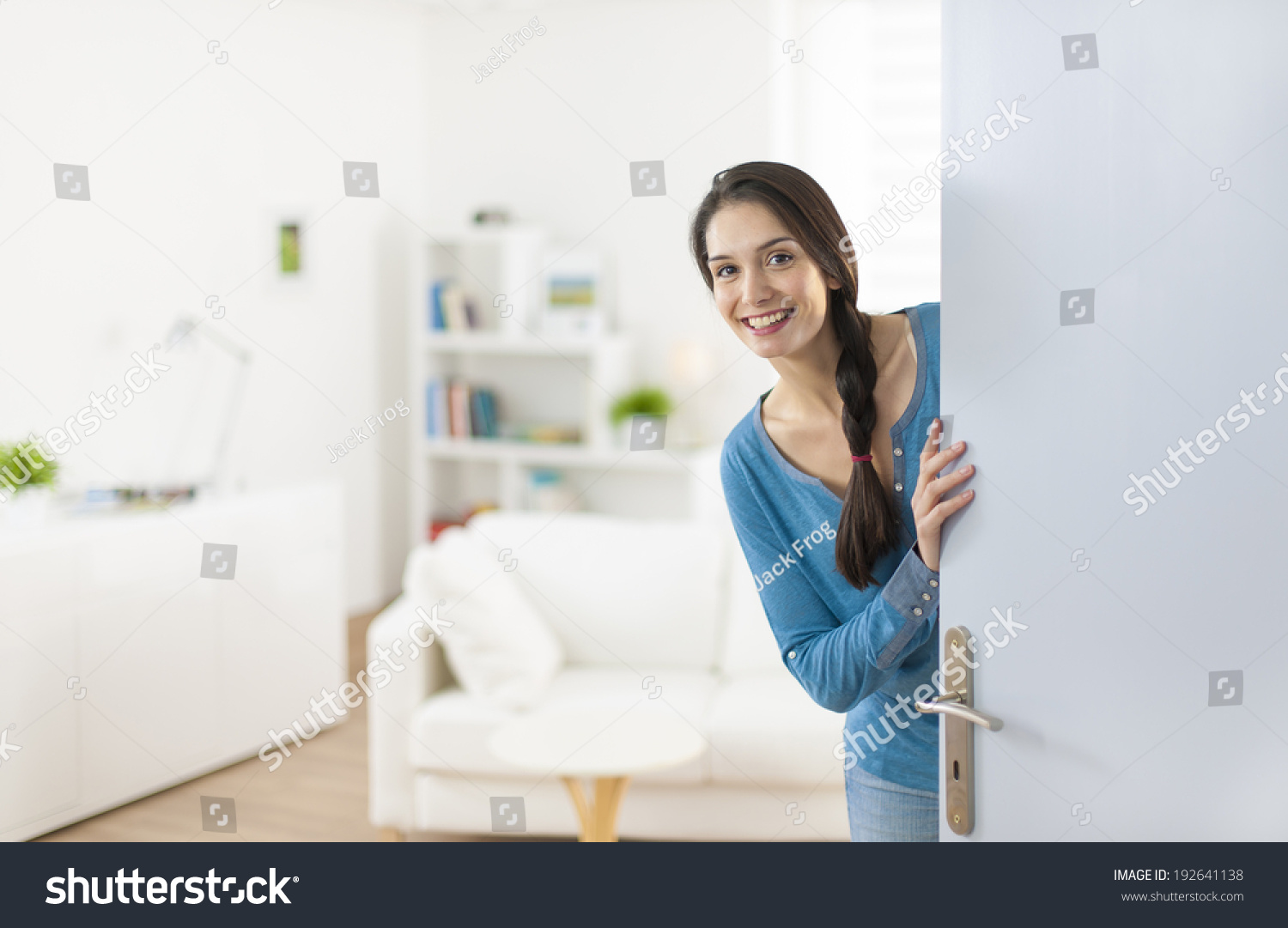 Cheerful woman inviting people to enter in home #192641138