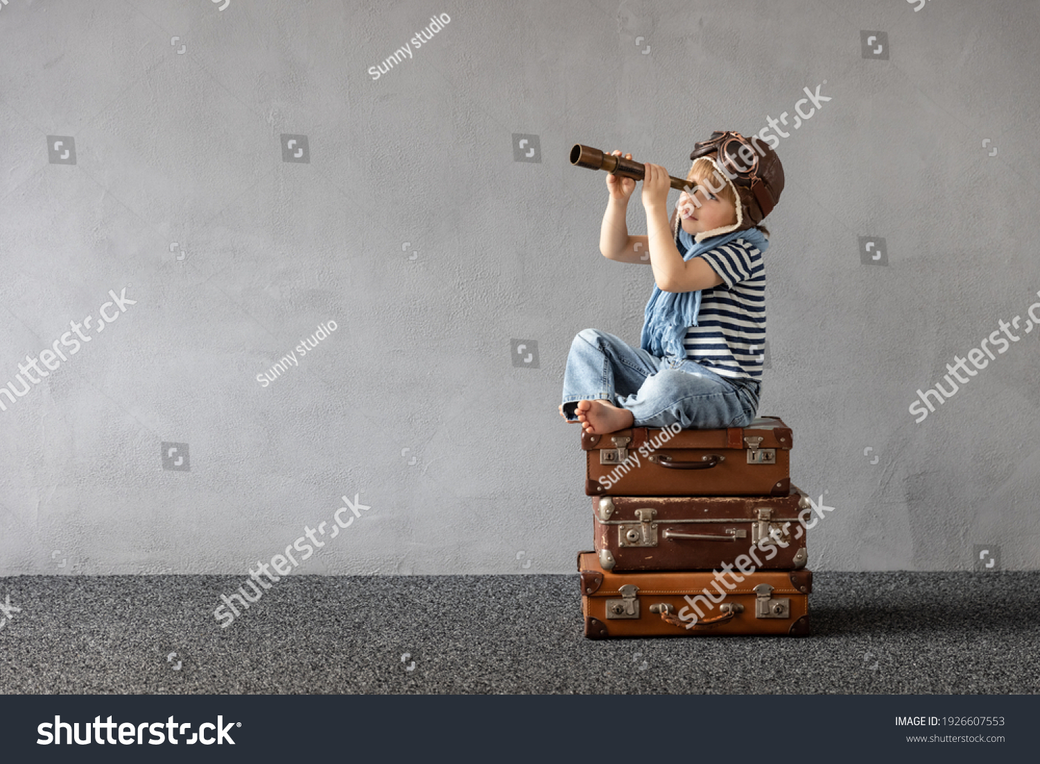 Happy child playing outdoor. Smiling kid dreaming about summer vacation and travel. Imagination and freedom concept #1926607553