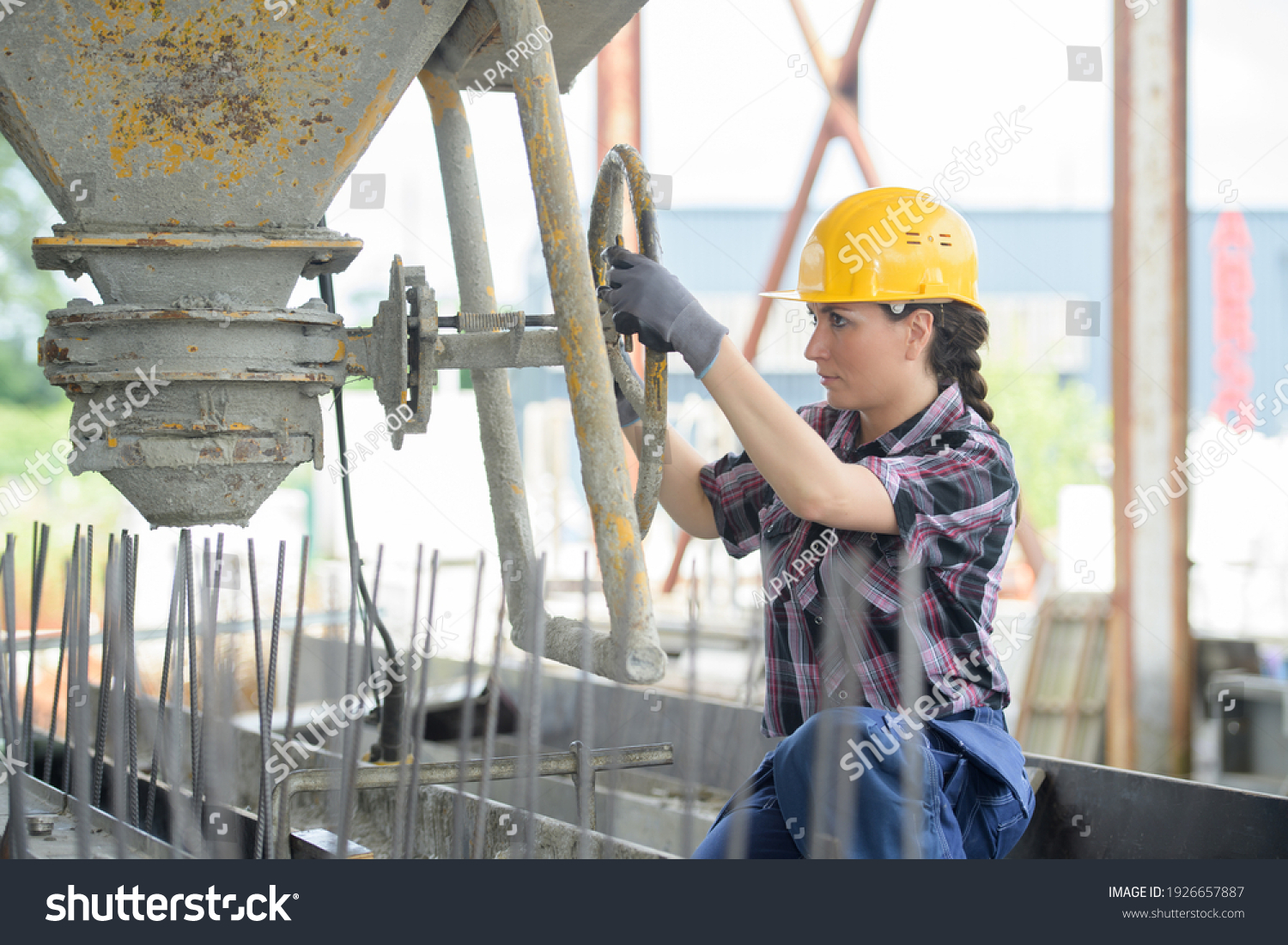 female woman mason working with cement outdoors #1926657887