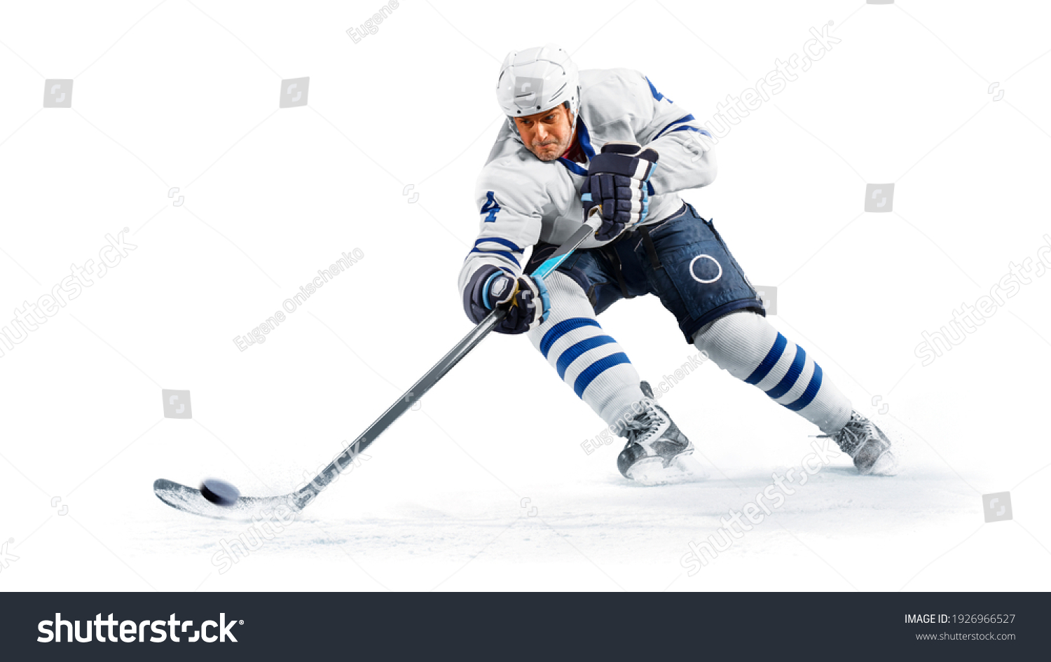 Portrait of energetic player playing hockey on ice #1926966527