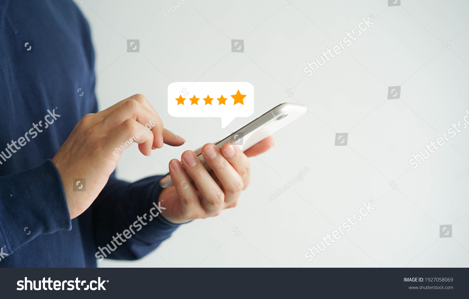 close up on customer man hand pressing on smartphone screen with gold five star rating feedback icon and press level excellent rank for giving best score point to review the service , business concept #1927058069