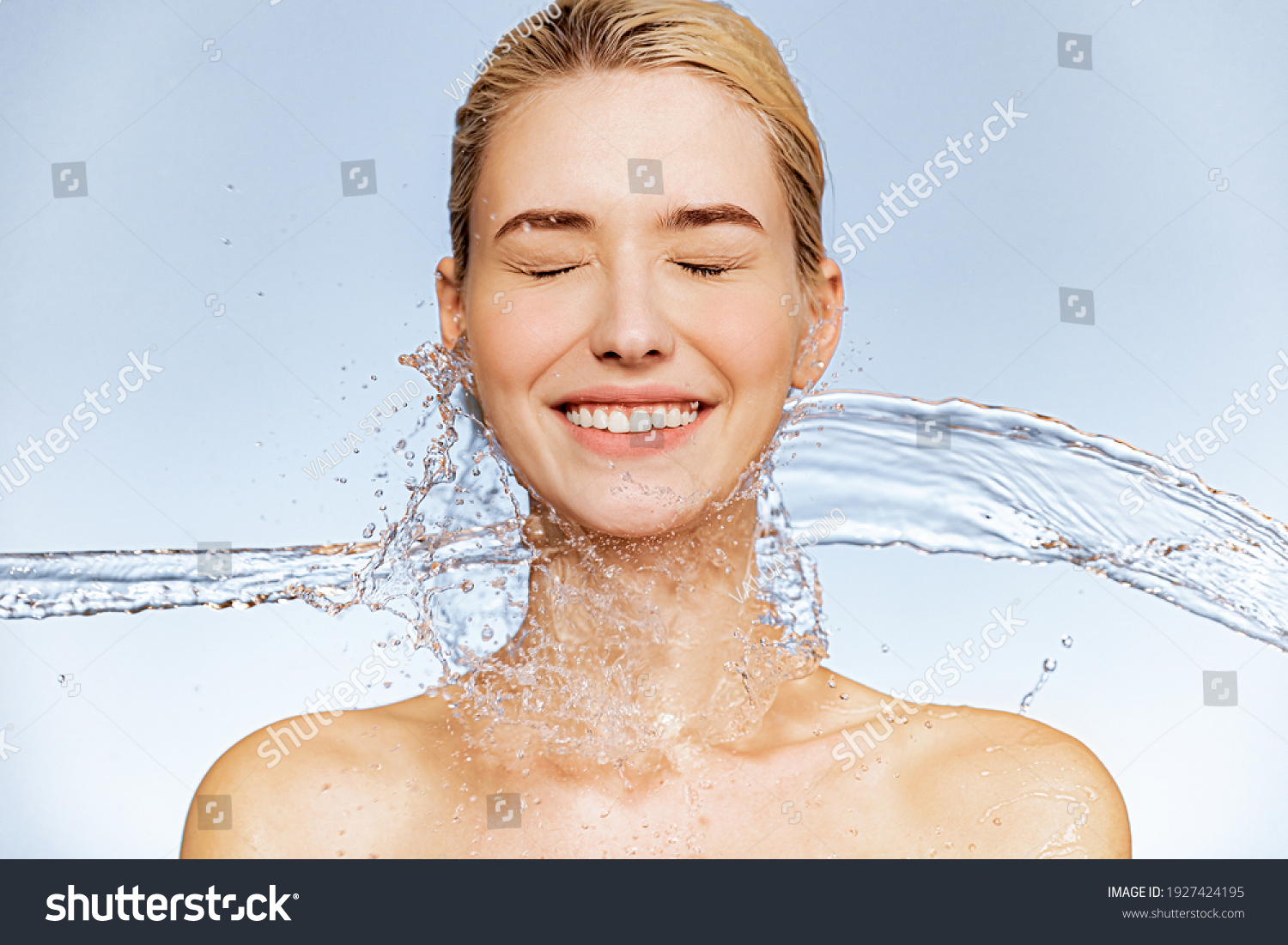 Photo of  young  woman with clean skin and splash of water. Portrait of smiling woman with drops of water around her face. Spa treatment. Girl washing her body with water. Water and body. #1927424195