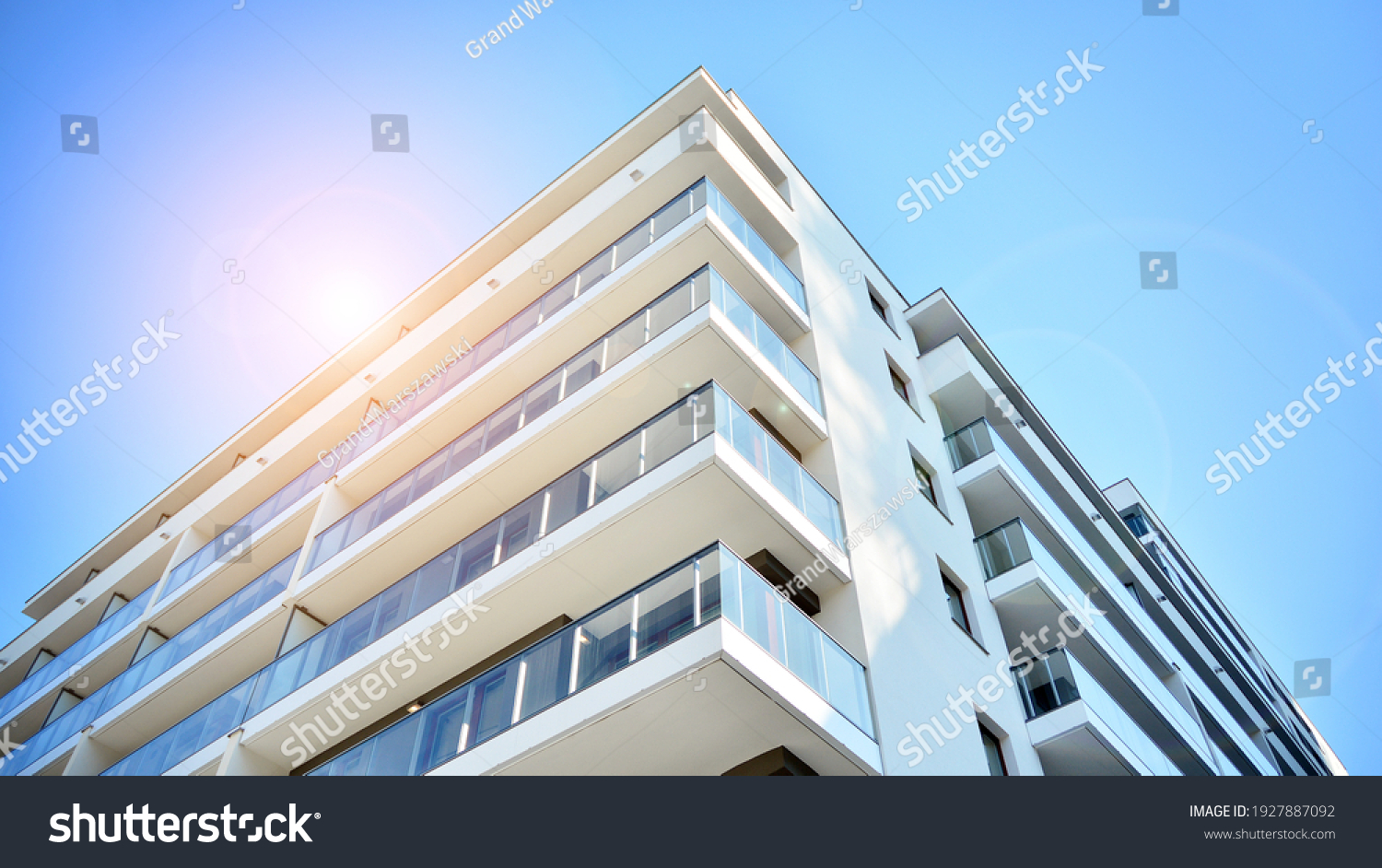 Apartment residential house and home facade architecture and outdoor facilities. Blue sky on the background. Sunlight in sunrise. #1927887092