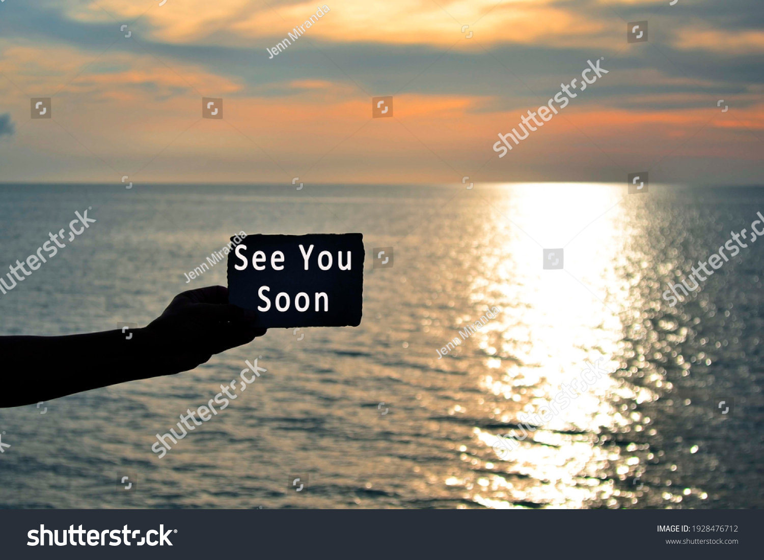 See you soon text on hand holding torn paper with blurred background of sunset at the beach of Tanjung Aru Beach, Kota Kinabalu, Borneo,Sabah, Malaysia #1928476712