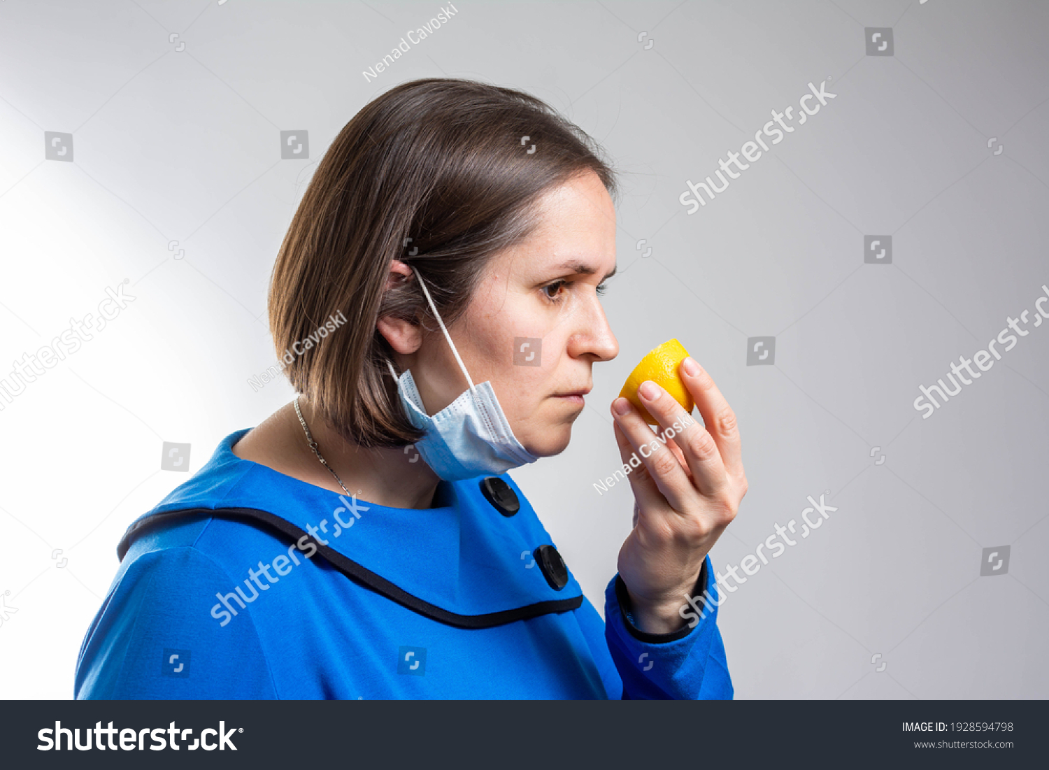 Anosmia or smell blindness, loss of the ability to smell, one of the possible symptoms of covid-19, infectious disease caused by corona virus. Man Trying to Sense Smell of a Lemon, side view. #1928594798