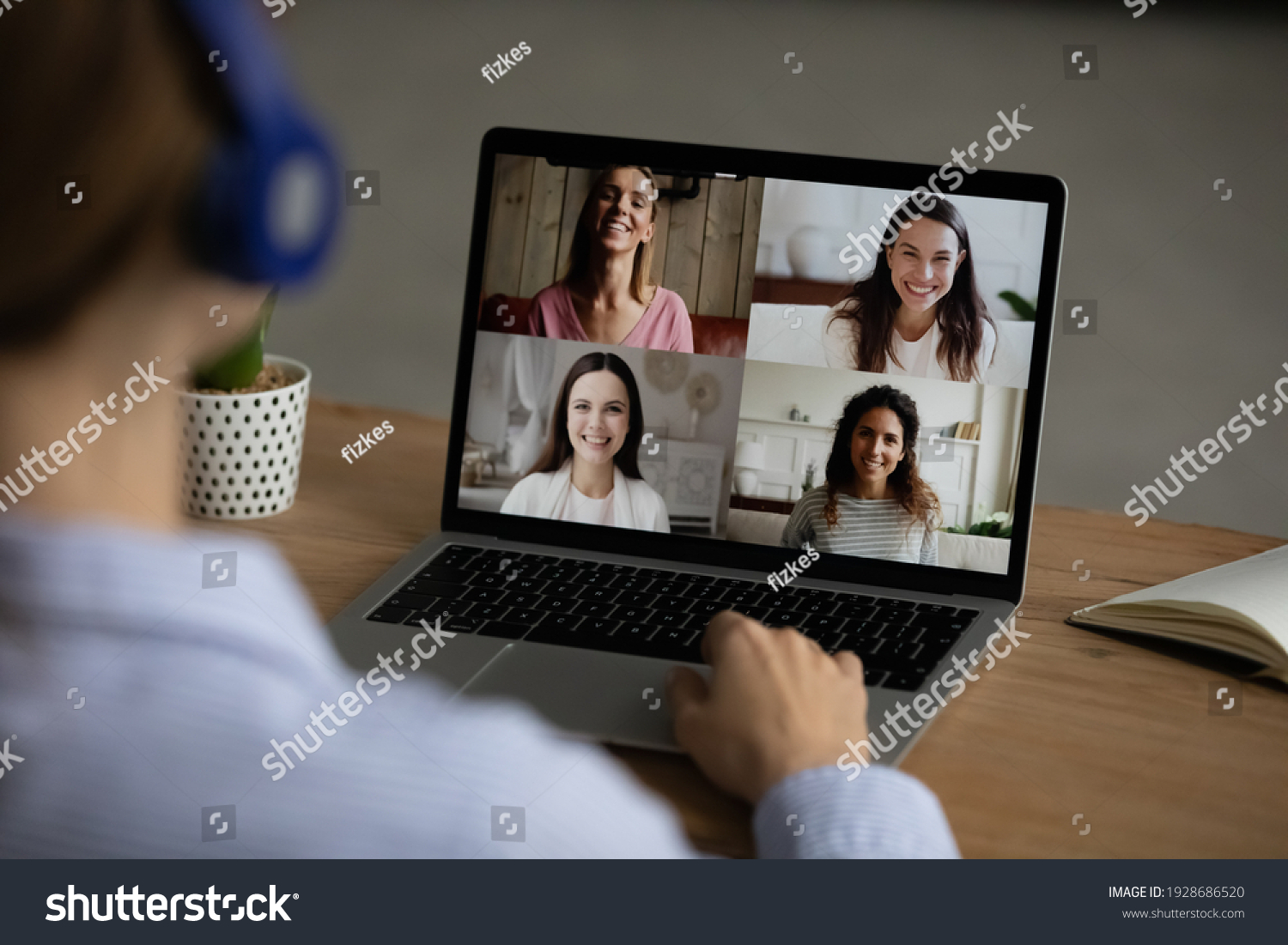 Over shoulder view of woman use laptop have pleasant webcam online conversation with diverse girlfriends. Female talk speak on video call with friends, laugh meeting on web. Virtual event concept. #1928686520