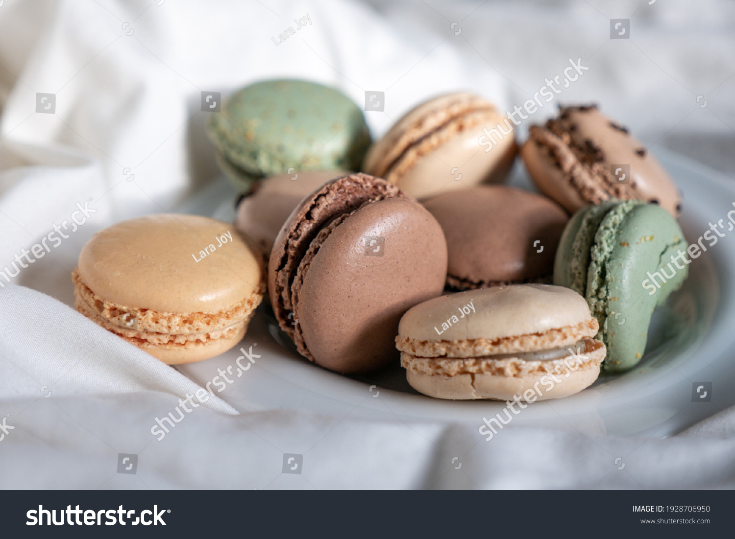 French Colorful Macarons Colorful Pastel Macarons on White Background green beige and Brown Macaron on plate dessert Sweet and colourful french macaroons pastry #1928706950