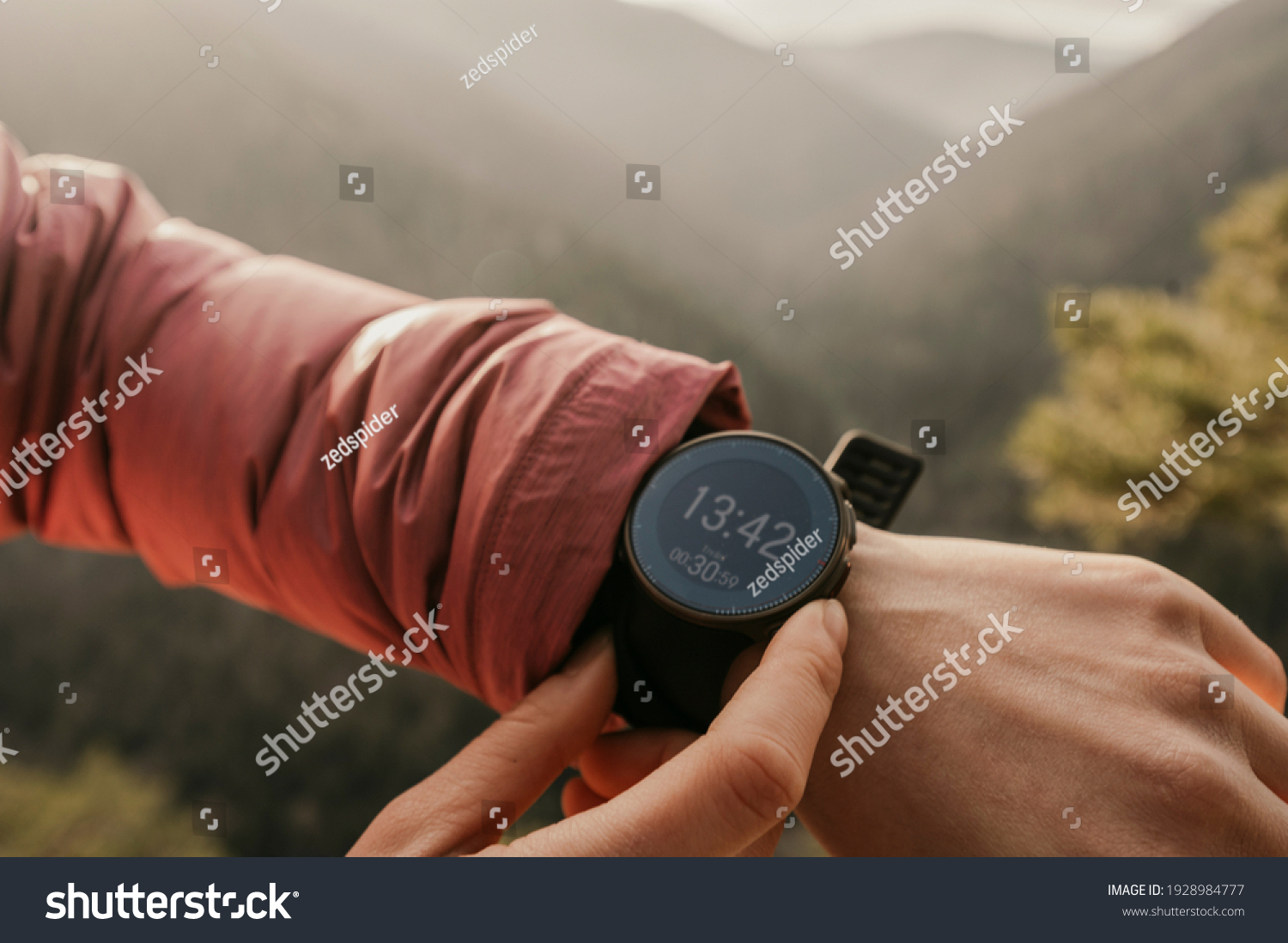 Woman looking app on sportwatch. Runner with heart rate monitor sports smart watch. Checking performance, GPS position or heart rate pulse #1928984777