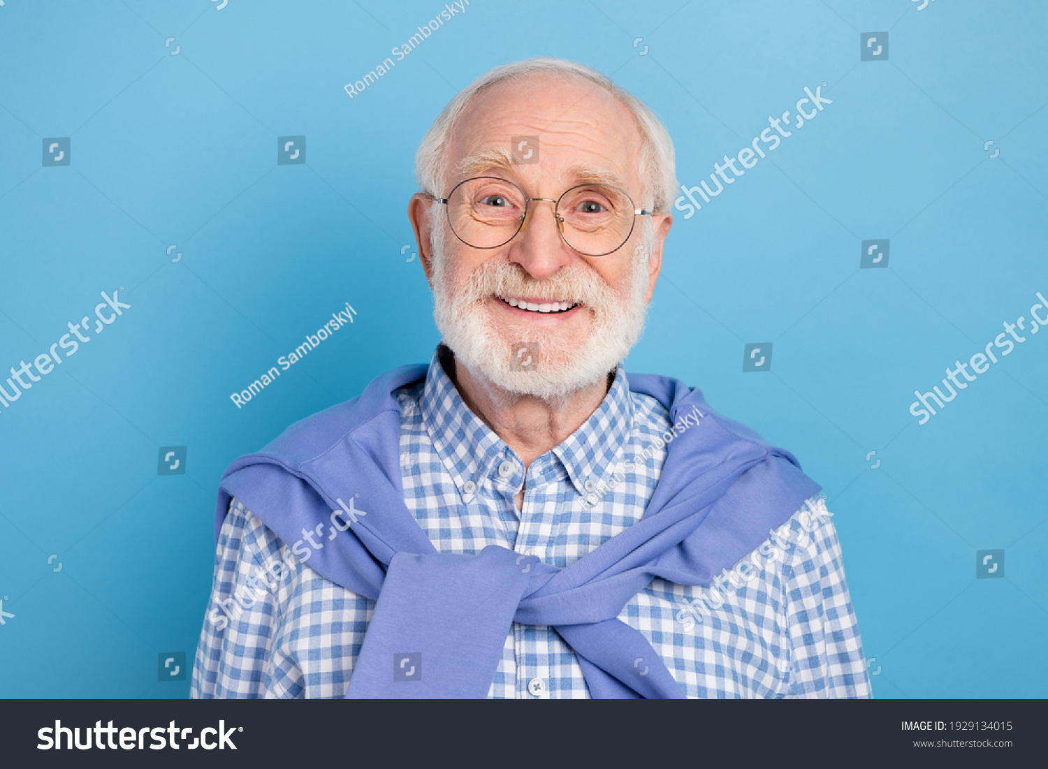 Portrait of cheerful aged man beaming smile look camera tied on neck pullover isolated on blue color background #1929134015
