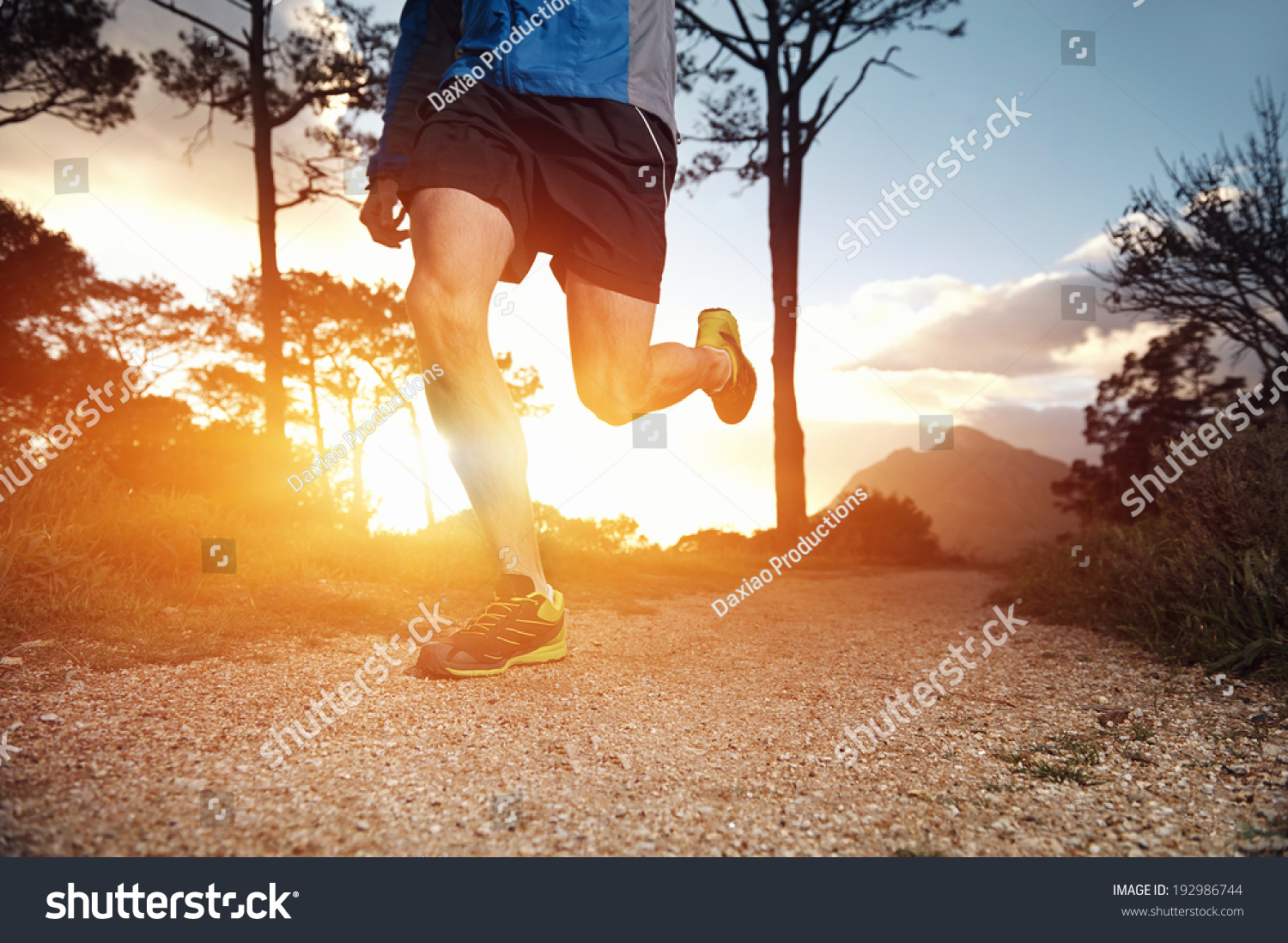 trail runner man exercising for fitness at sunrise in mountains doing sport #192986744