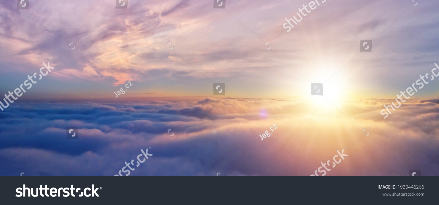Beautiful sunset cloudy sky from aerial view. Airplane view above clouds #1930446266