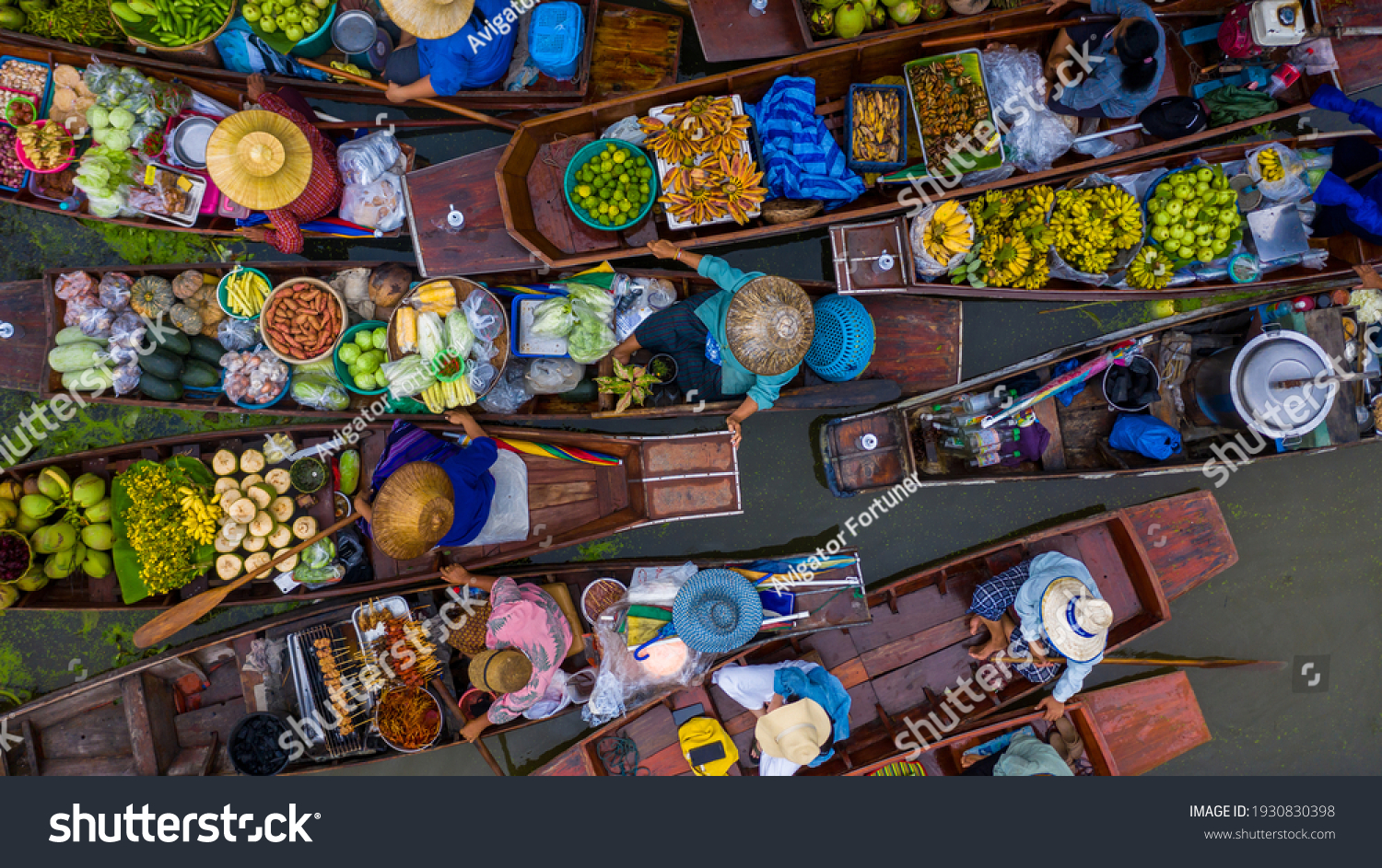 Aerial view famous floating market in Thailand, Damnoen Saduak floating market, Farmer go to sell organic products, fruits, vegetables and Thai cuisine, Tourists visiting by boat, Ratchaburi, Thailand #1930830398