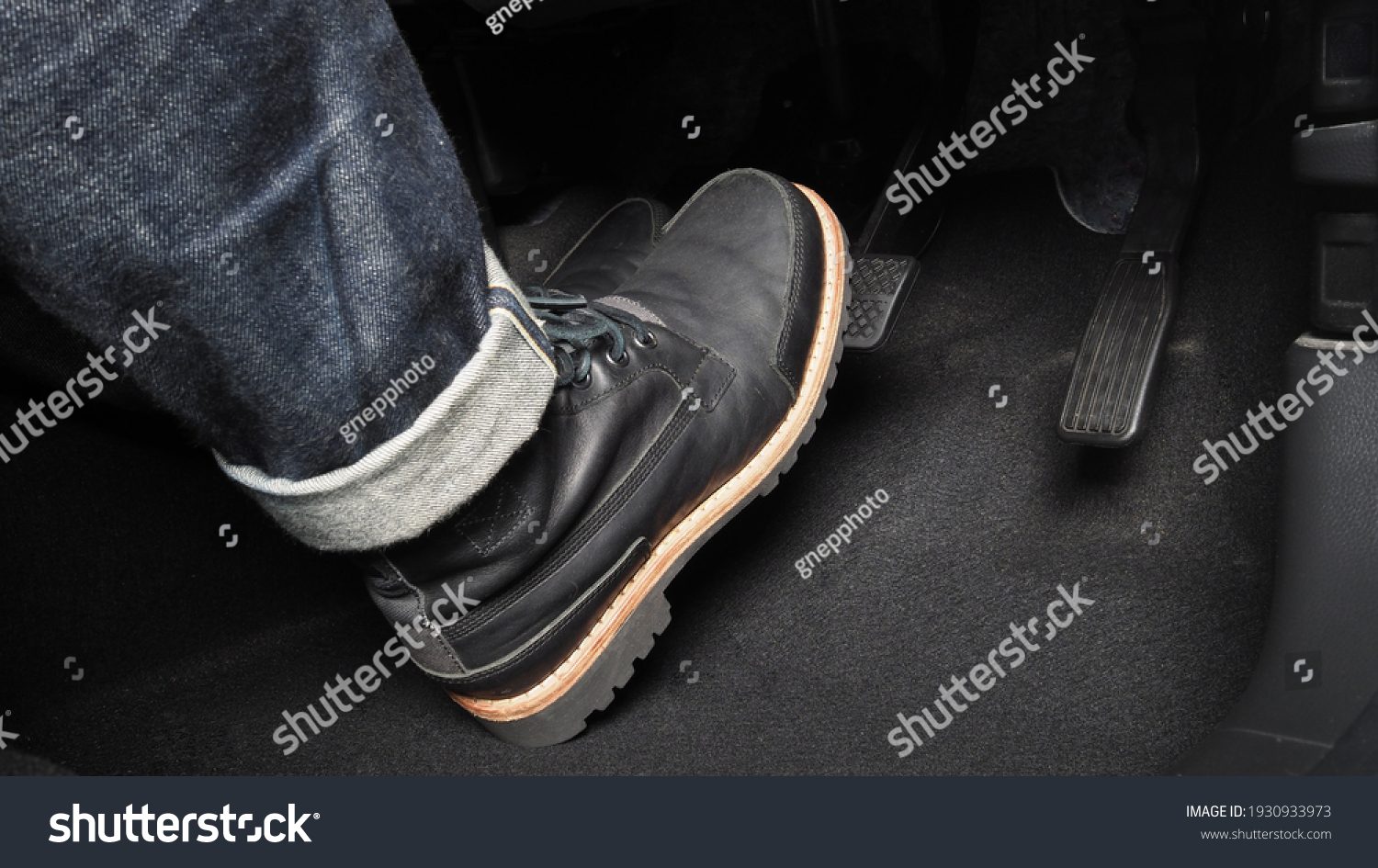 Accelerator and breaking pedal in a car. Close up the foot pressing foot pedal of a car to drive ahead. Driver driving the car by pushing accelerator pedals of the car. inside vehicle. 
 #1930933973