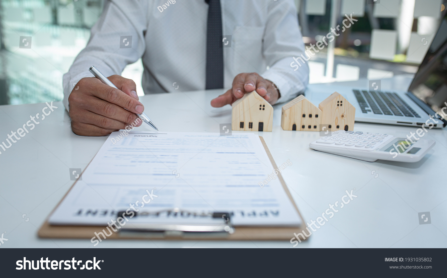 Real estate agent and customer signing contract to buy house, insurance or loan real estate.rent a house,get insurance or loan real estate or property. #1931035802