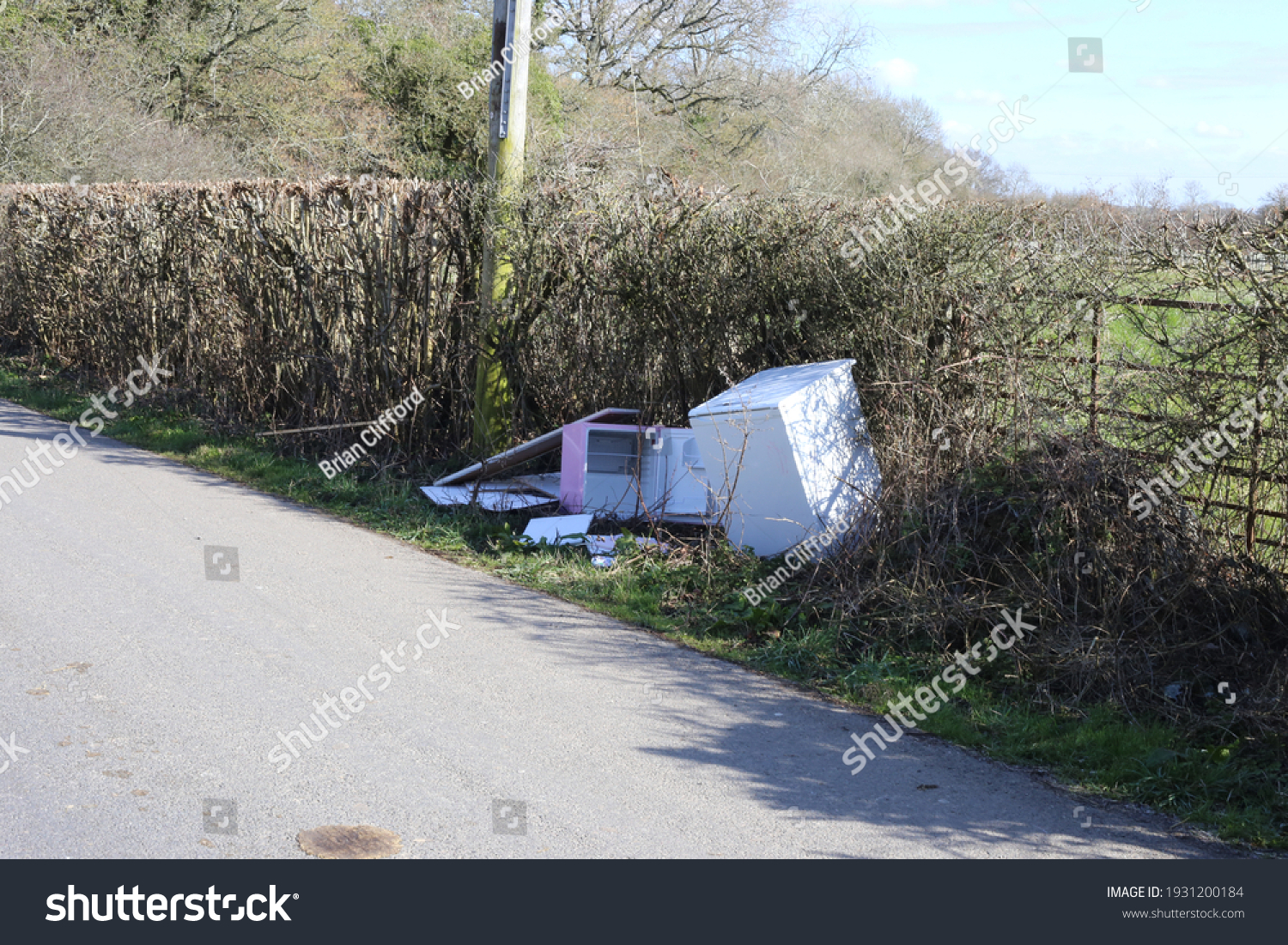 Fly tipped rubbish on a country lane #1931200184
