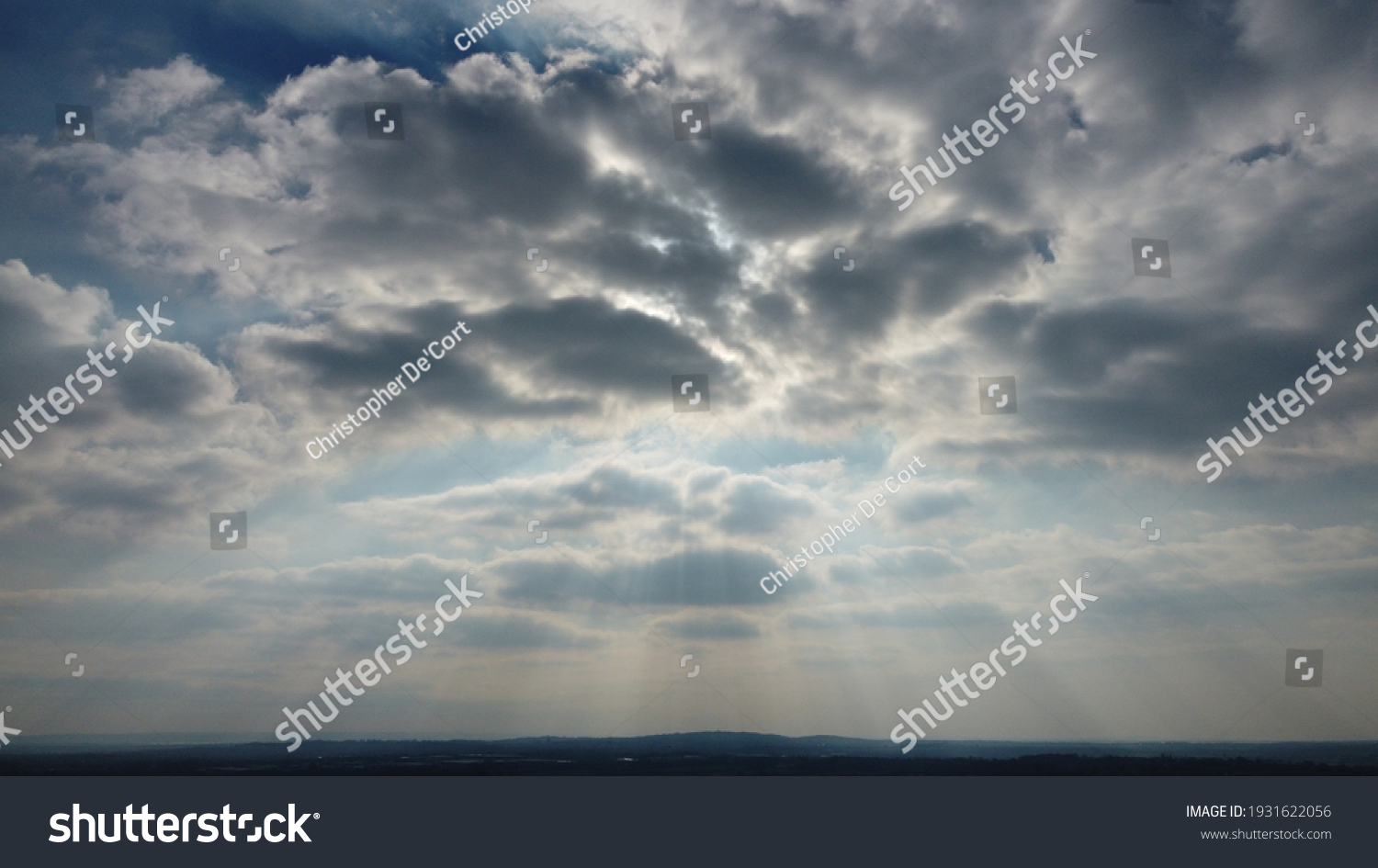 Sun rays bursting through clouds #1931622056