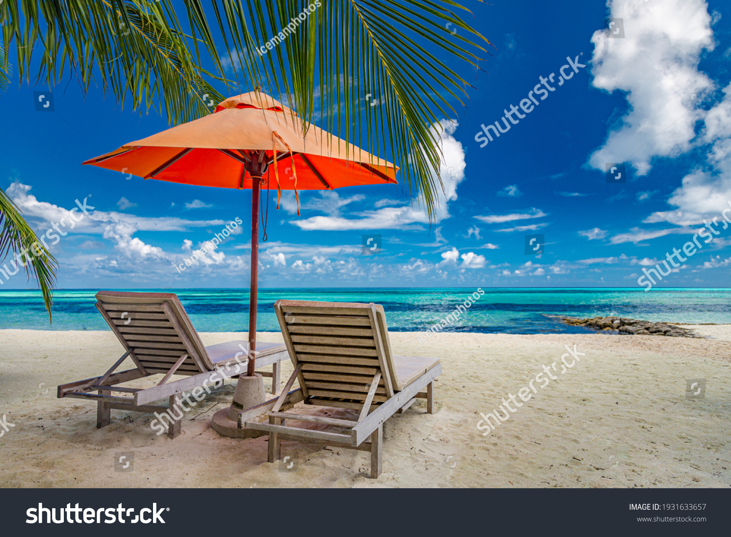 Beautiful tropical island scenery, two sun beds, loungers, umbrella under palm tree. White sand, sea view with horizon, idyllic blue sky, calmness and relaxation. Inspirational beach resort hotel #1931633657