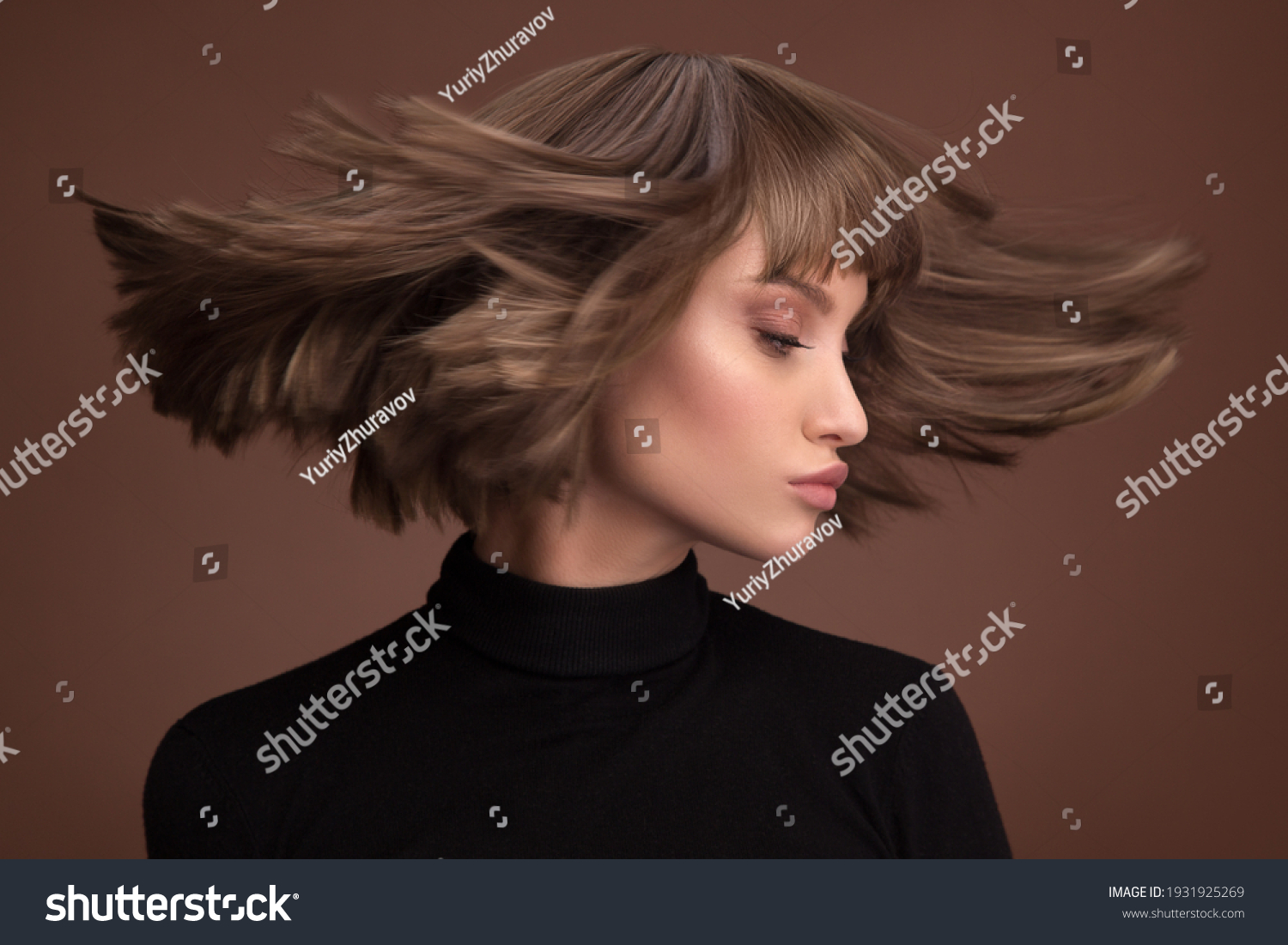Portrait of a beautiful brown-haired woman with a short haircut on a brown background #1931925269