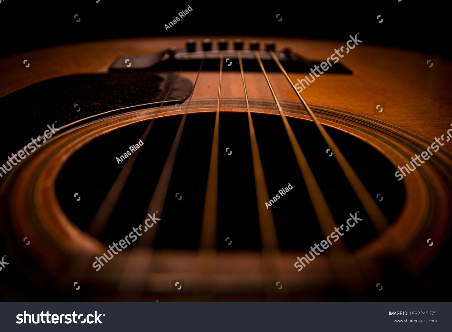 Guitar.Guitar's chords.Acoustic guitar.Music.Music background.Image of an acoustic guitar in the dark.Playing music with some friends in the dark.Classical music.Closeup image of an acoustic guitar. #1932245675