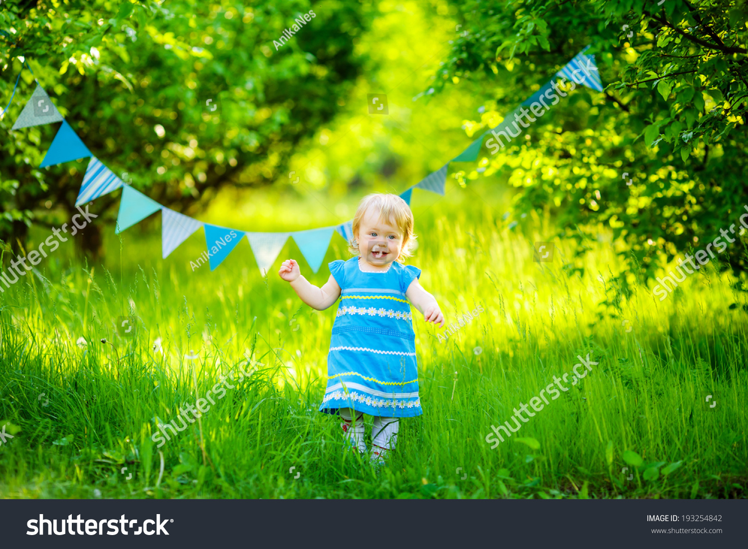 beautiful little girl blue dress on the nature #193254842