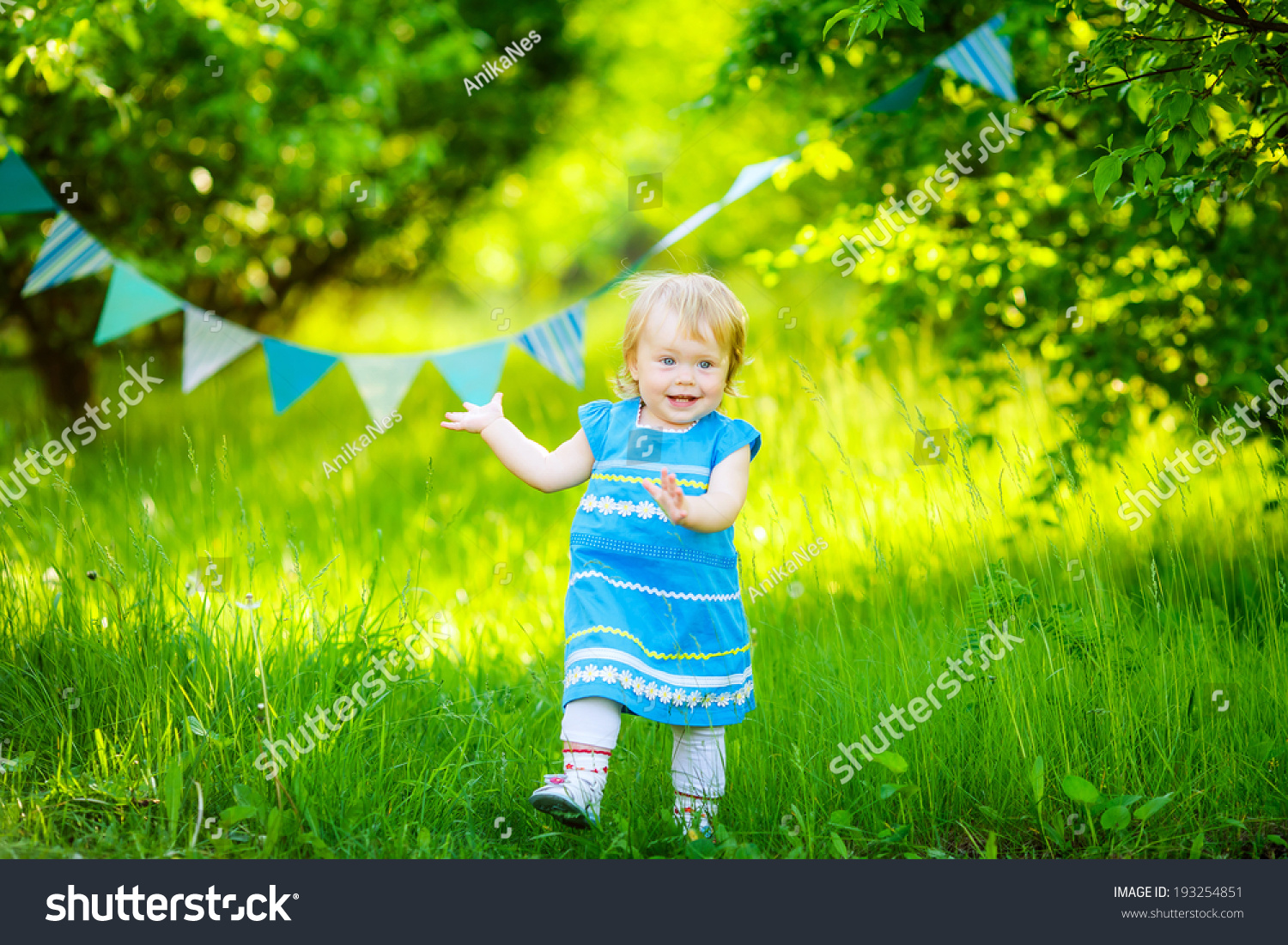 beautiful little girl blue dress on the nature #193254851