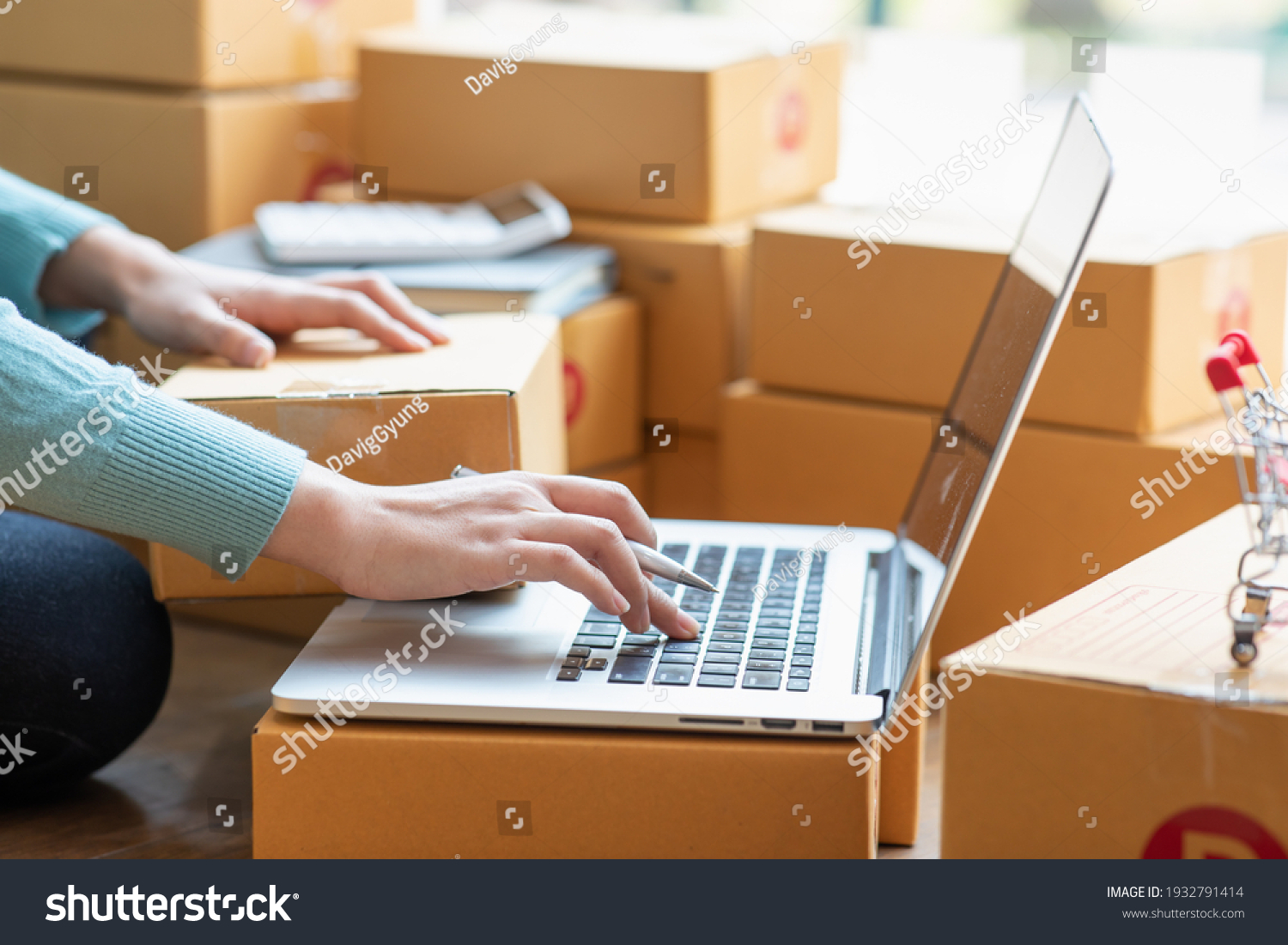 Starting small businesses SME owners female entrepreneurs Write the address on receipt box and check online orders to prepare to pack the boxes, sell to customers, sme business ideas online. #1932791414