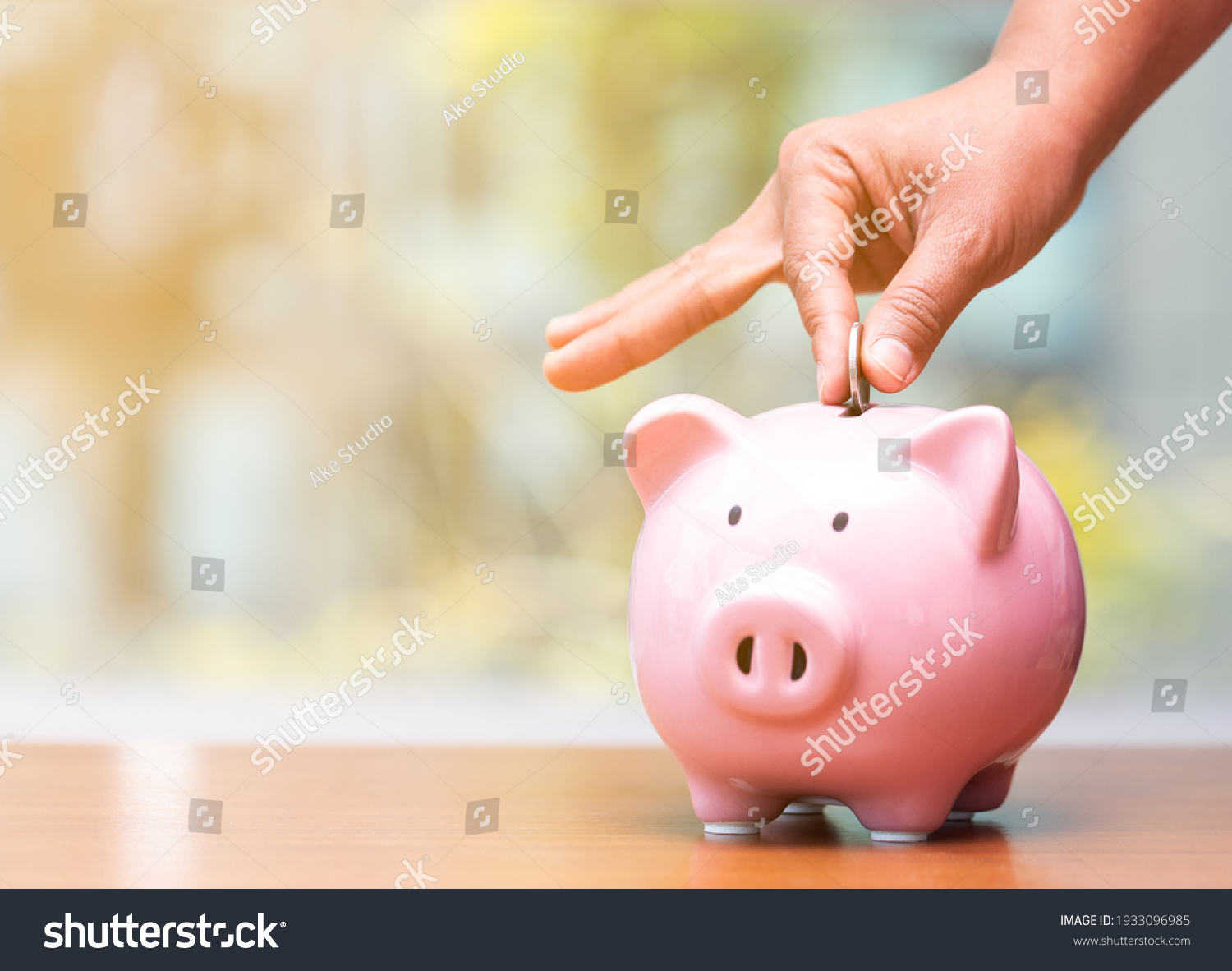 Concept hand putting money coin into piggy bank saving money for future plan and retirement fund, Business or finance saving show putting coin saving and investment money  retro vintage color tone. #1933096985