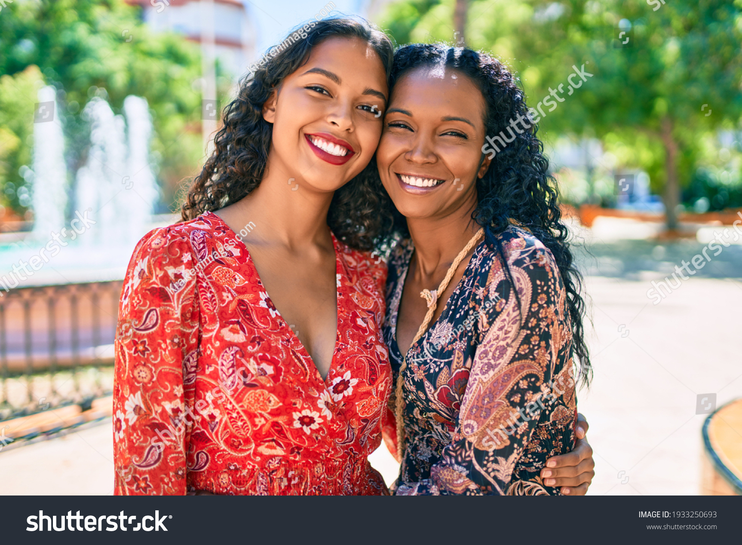 African american mother and daughter smiling happy hugging at the park. #1933250693