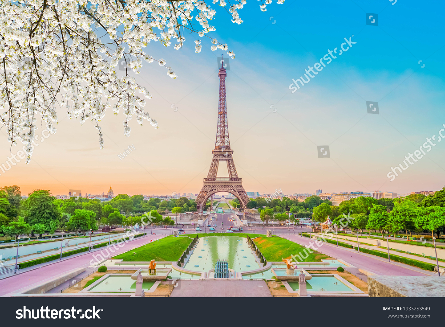 Paris Eiffel Tower and Trocadero garden at spring sunset in Paris, France. Eiffel Tower is one of the most famous landmarks of Paris., toned #1933253549
