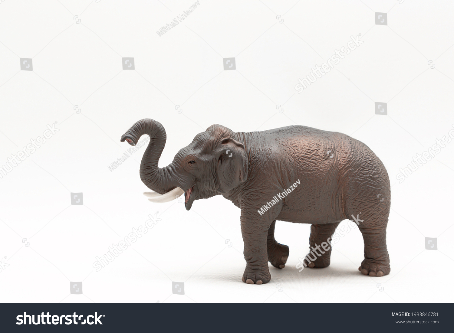 Realistic miniature elephant figure isolated on a white background. Elephant Toy. Copy space #1933846781